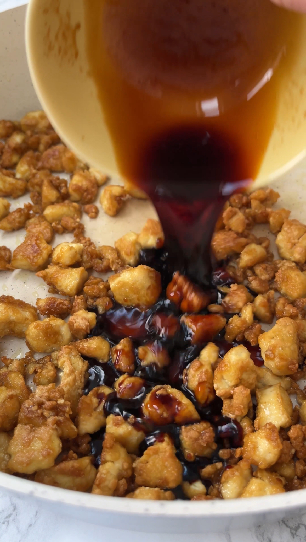 adding a sticky sauce to make the tofu nice and coated