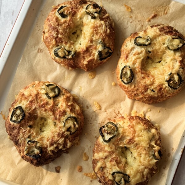 3 ingredient bagel with cheese and jalapeno on a tray.