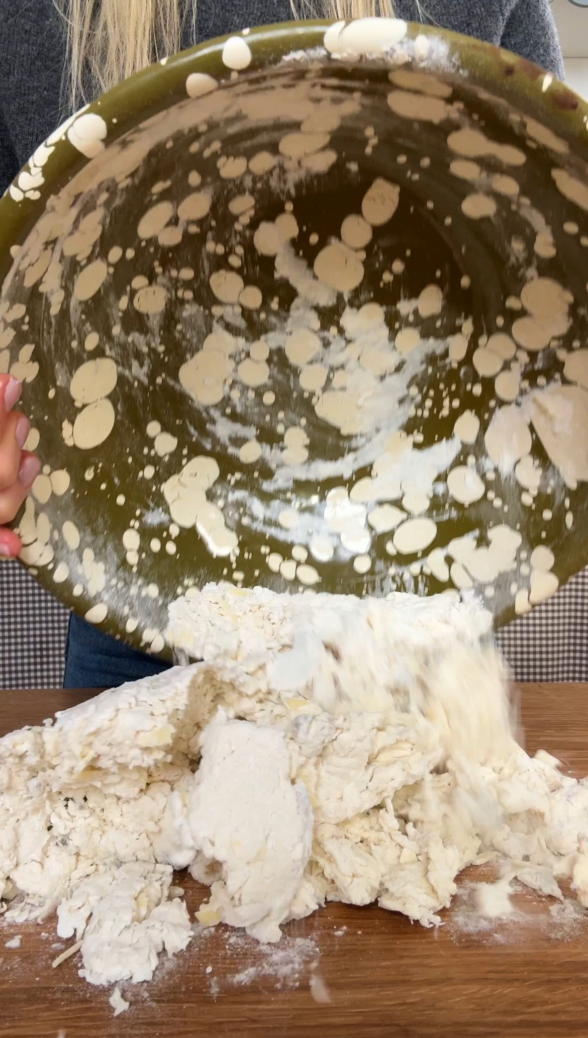 tipping the bagel dough onto a surface to knead.