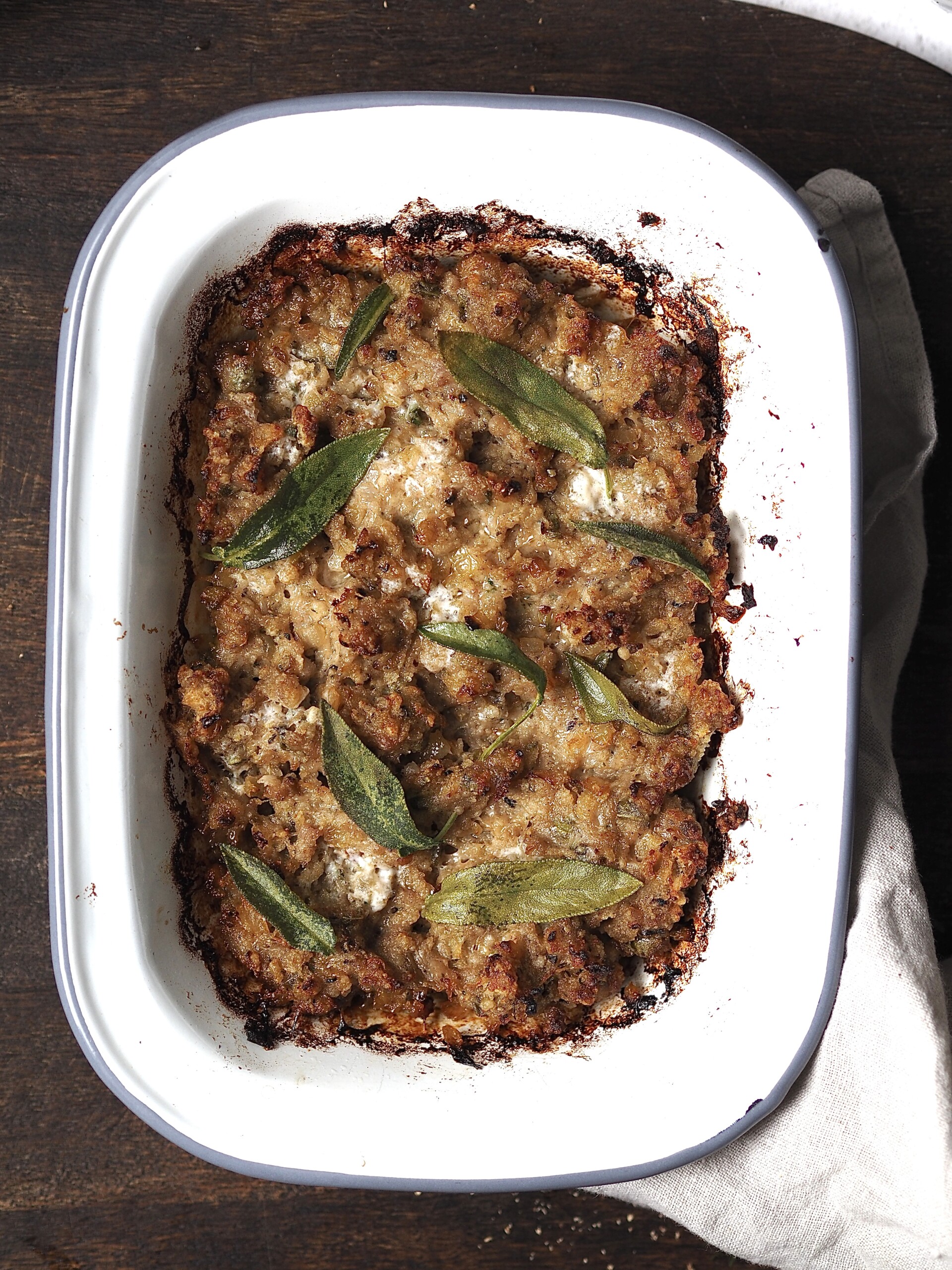 Close up of a dish of baked sausage, onion and sage stuffing. 