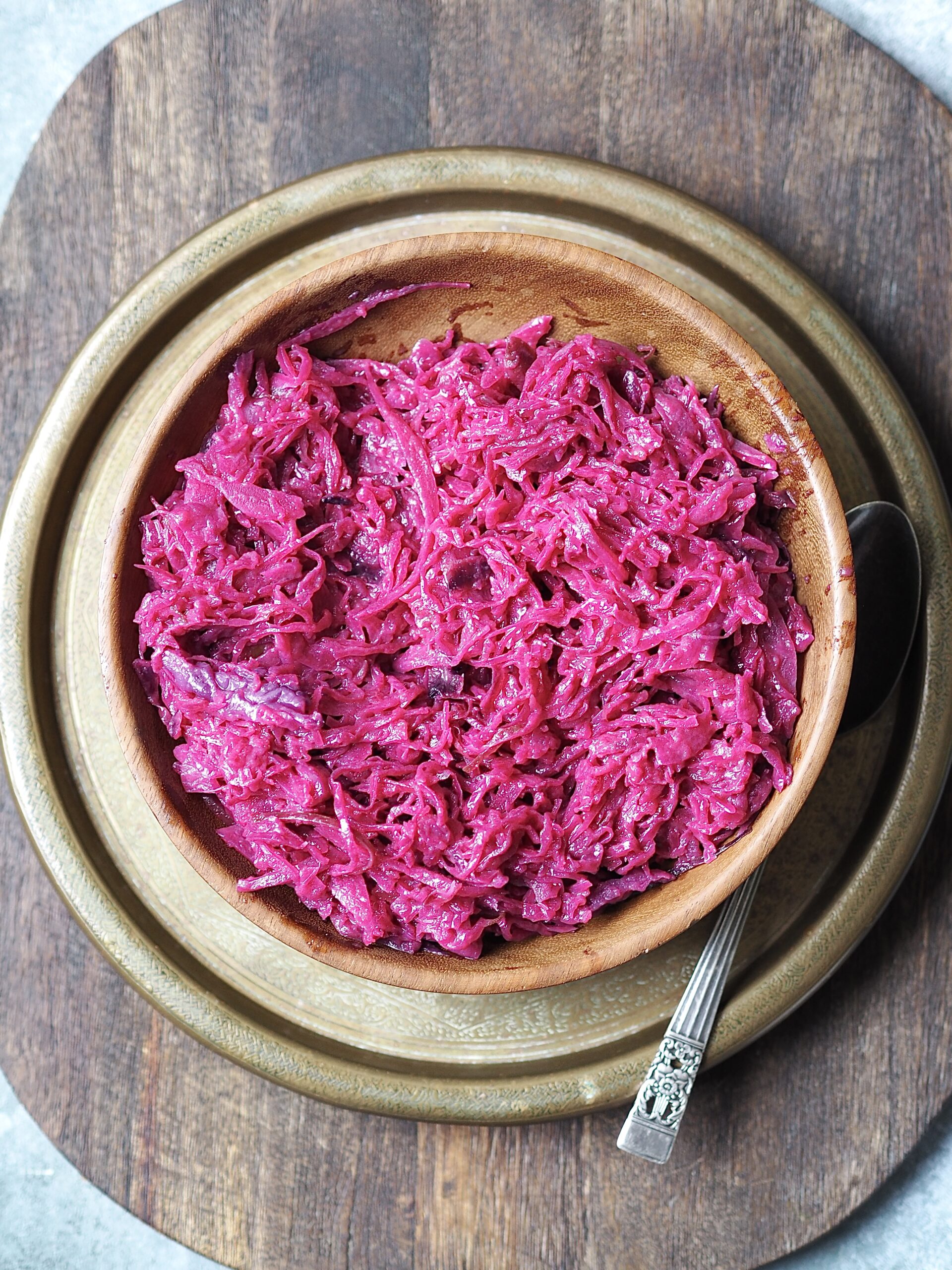 Wooden serving bowl of cooked red cabbage.