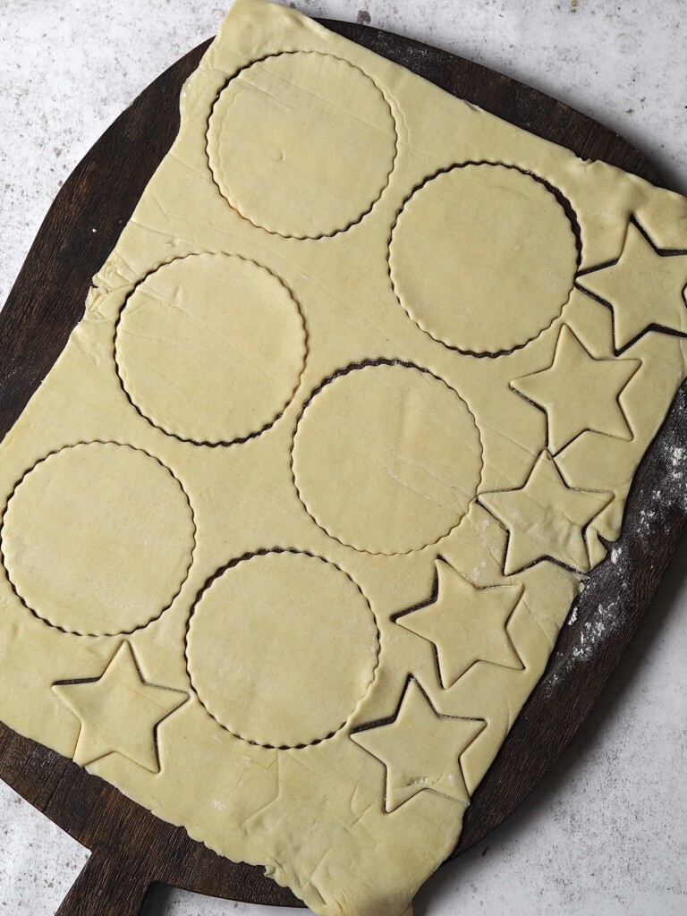 Pastry shapes being cut out of a pastry sheet.