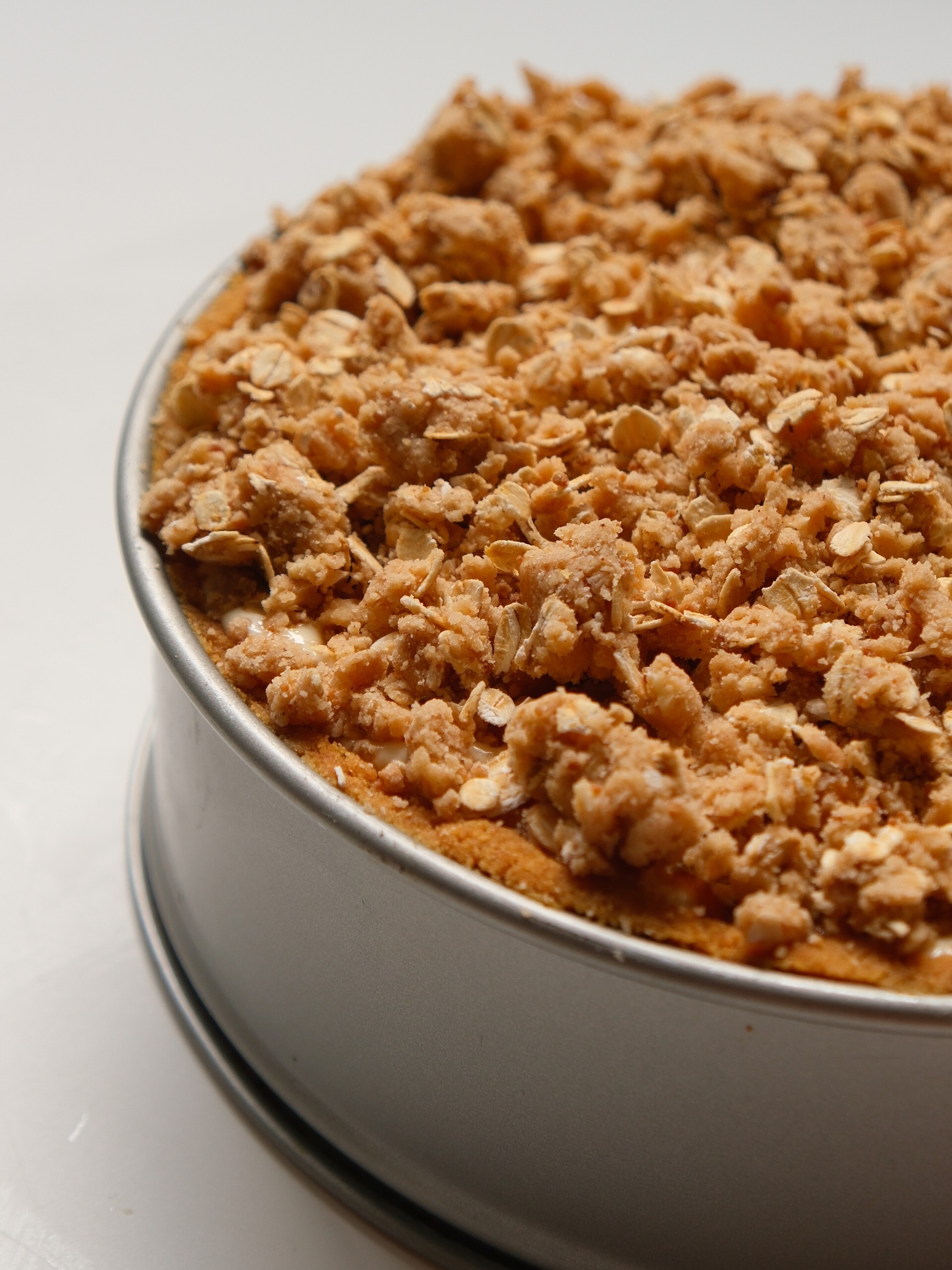 Apple Crumble Cheesecake in a baking tin