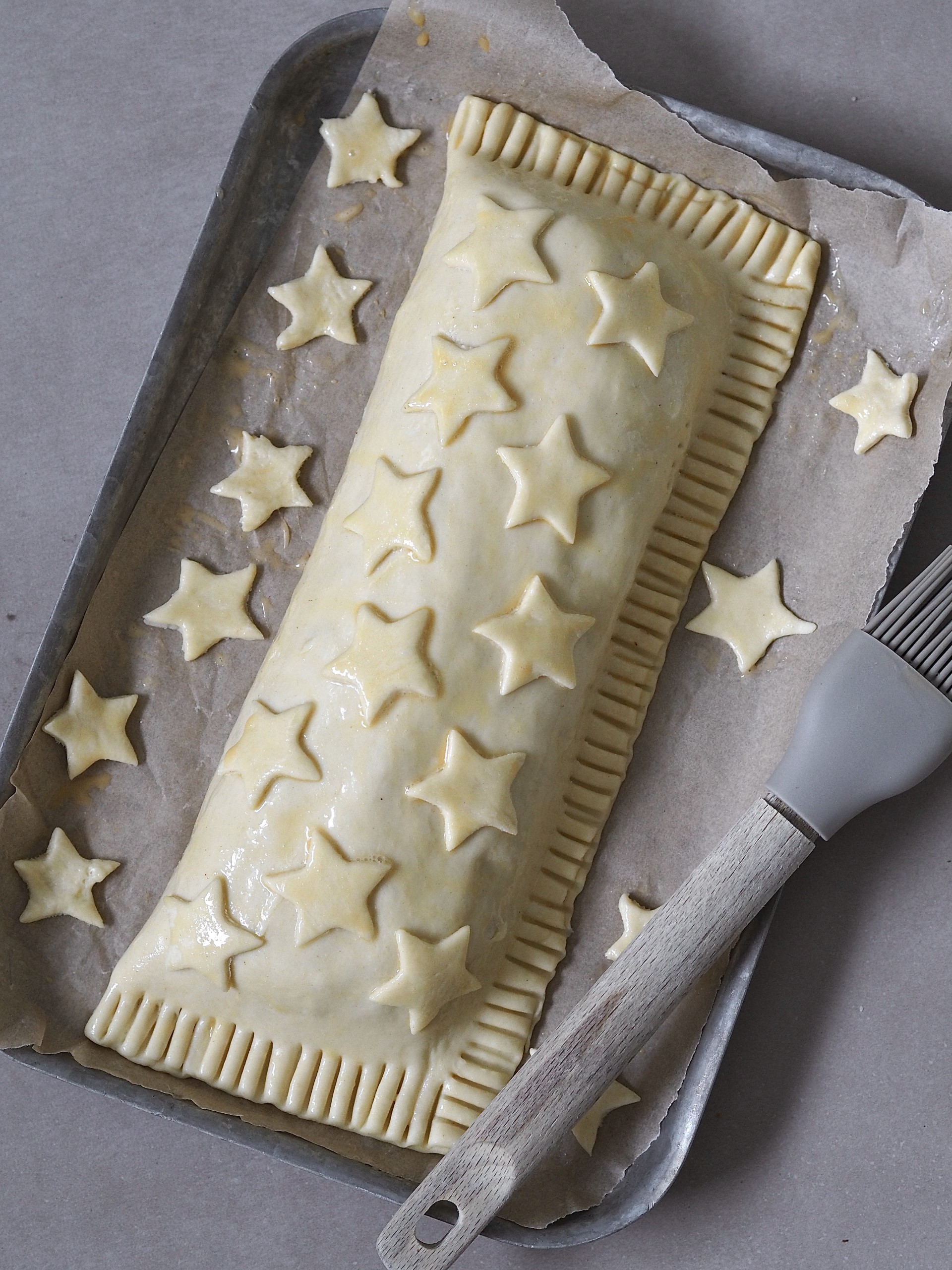 Brushing the pastry with egg mixture and adding decoration