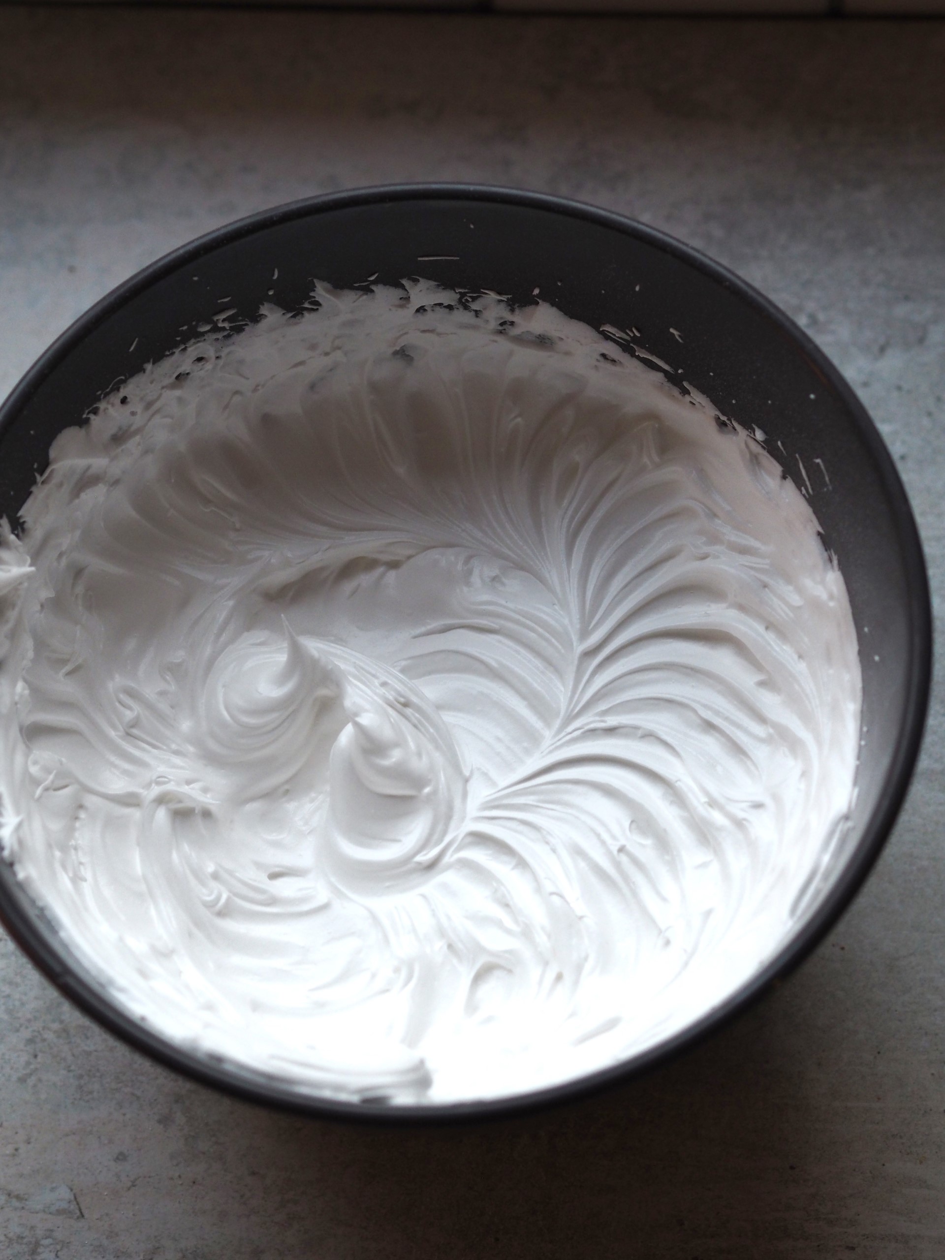 Whisked egg whites in a bowl