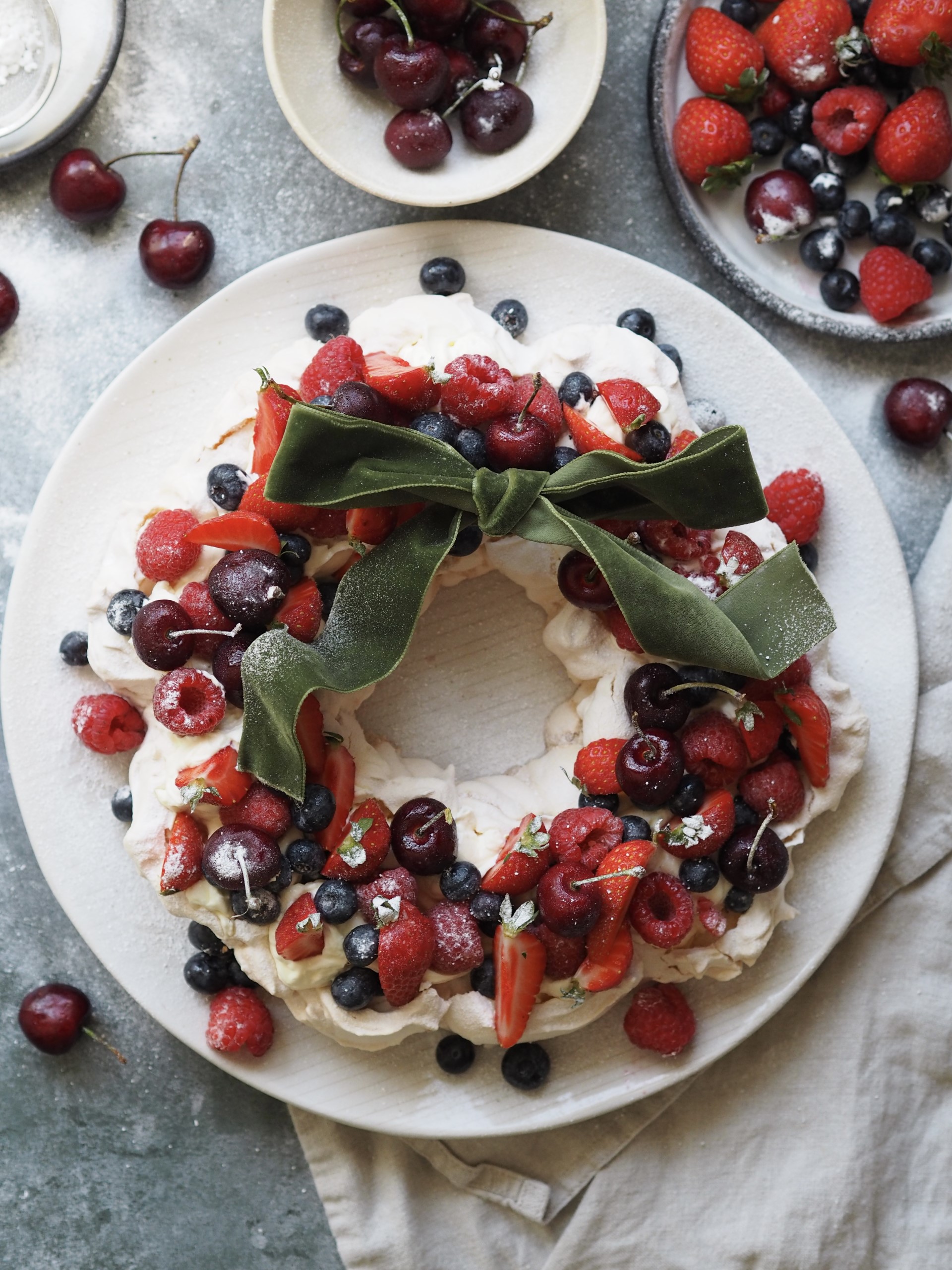 Christmas Pavlova on a plate with berries and cherries