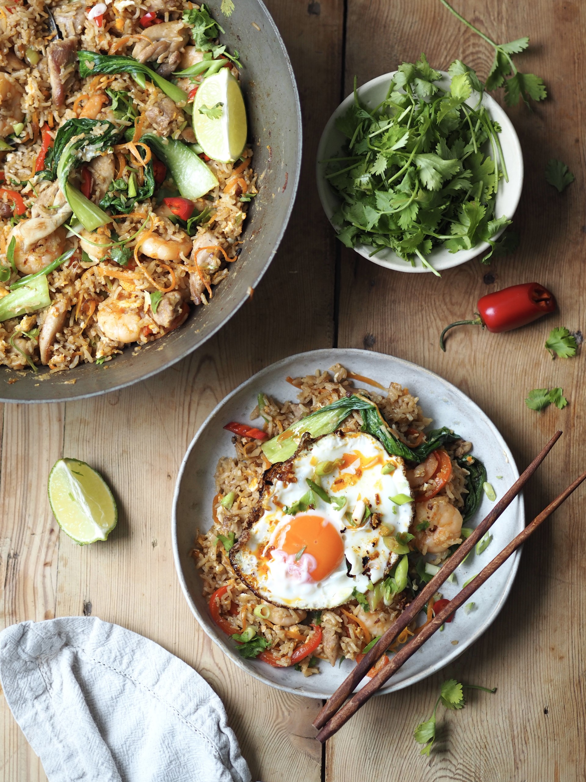 Pan with Shrimp and Chicken Fried Rice and a bowl of Shrimp and Chicken Fried Rice with a fried egg.