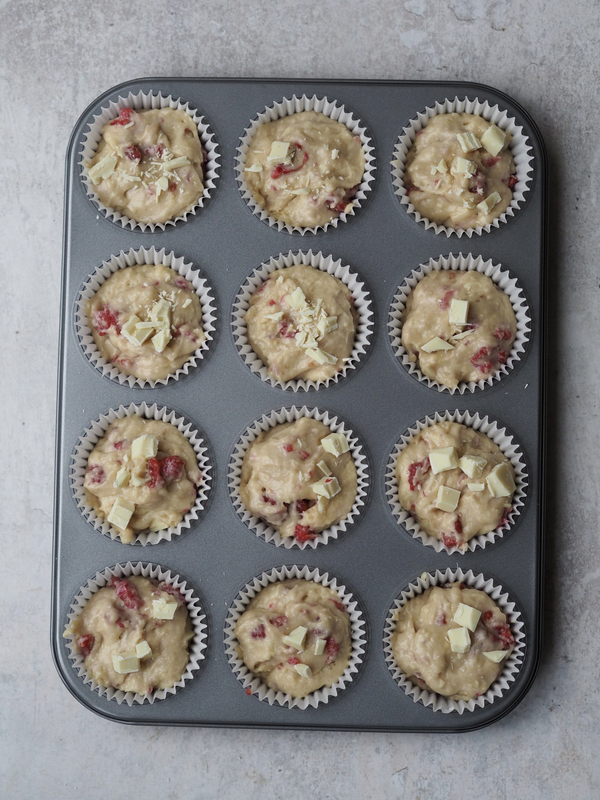 Unbaked batter in a muffin pan