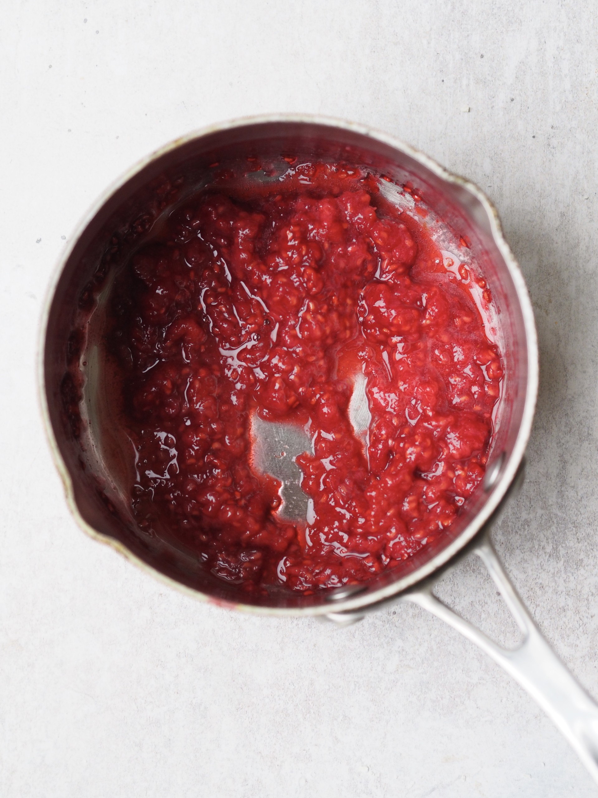 Cooked raspberries in a sauce pan