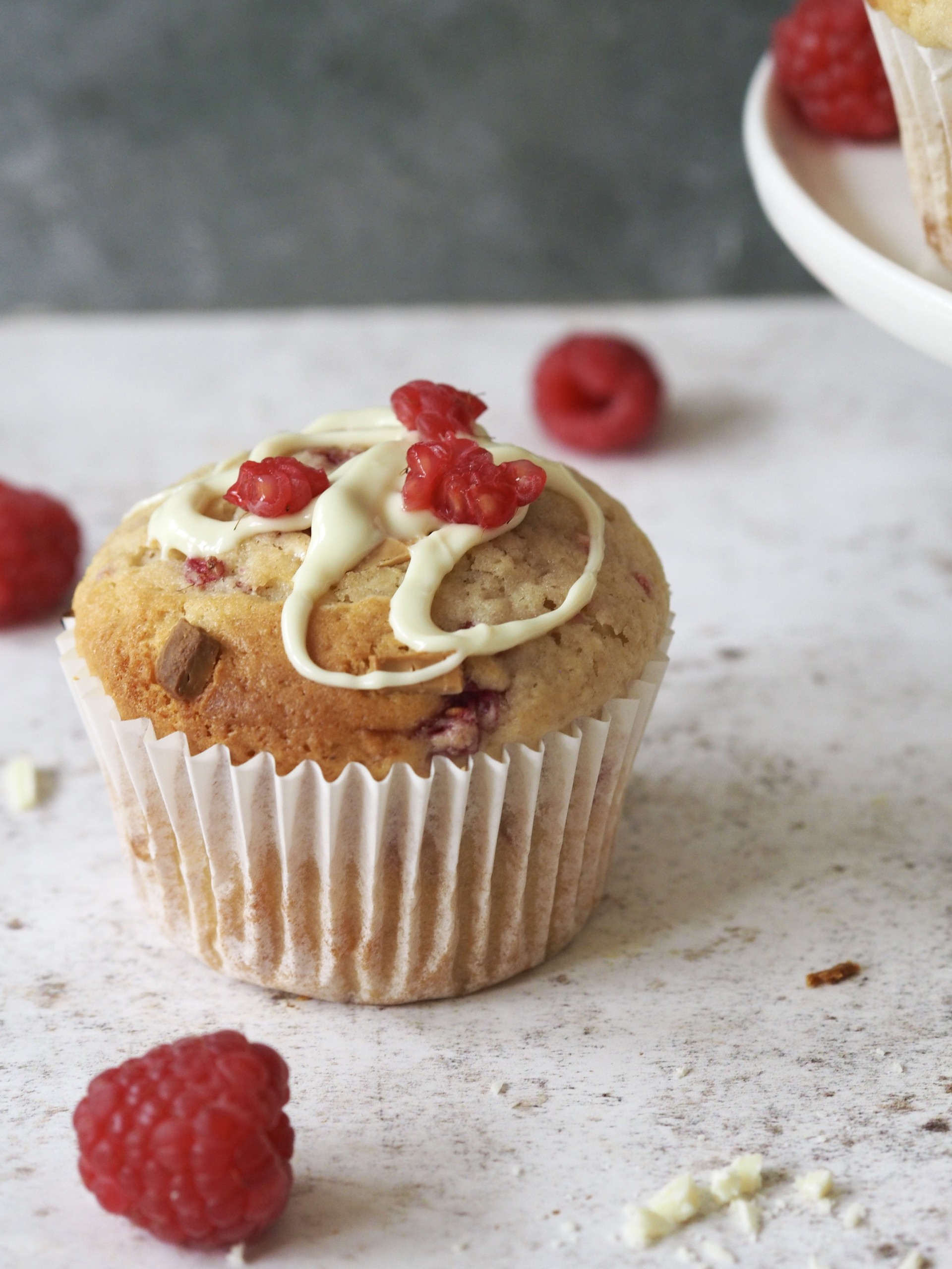 Asingle muffin with fresh raspberries