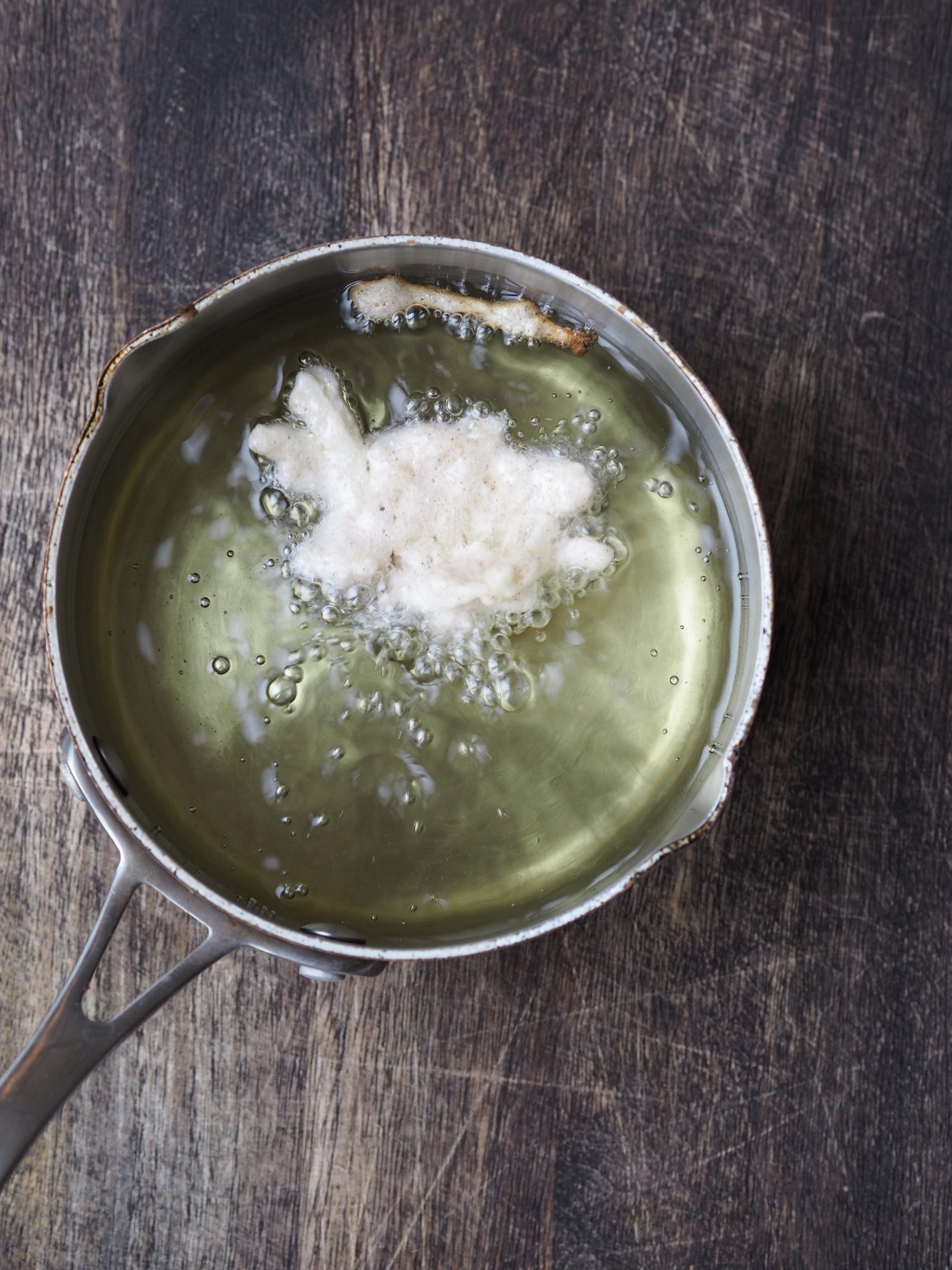 Adding batter to hot oil in a sauce pan