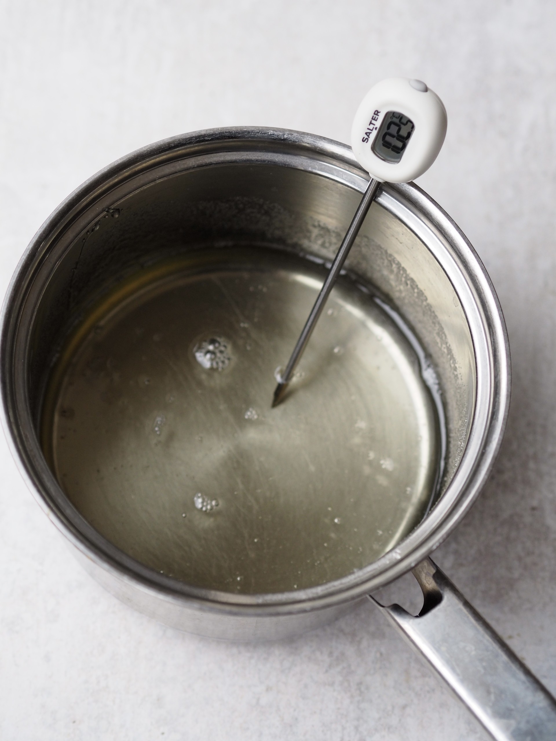 A sauce pan with a thermometer