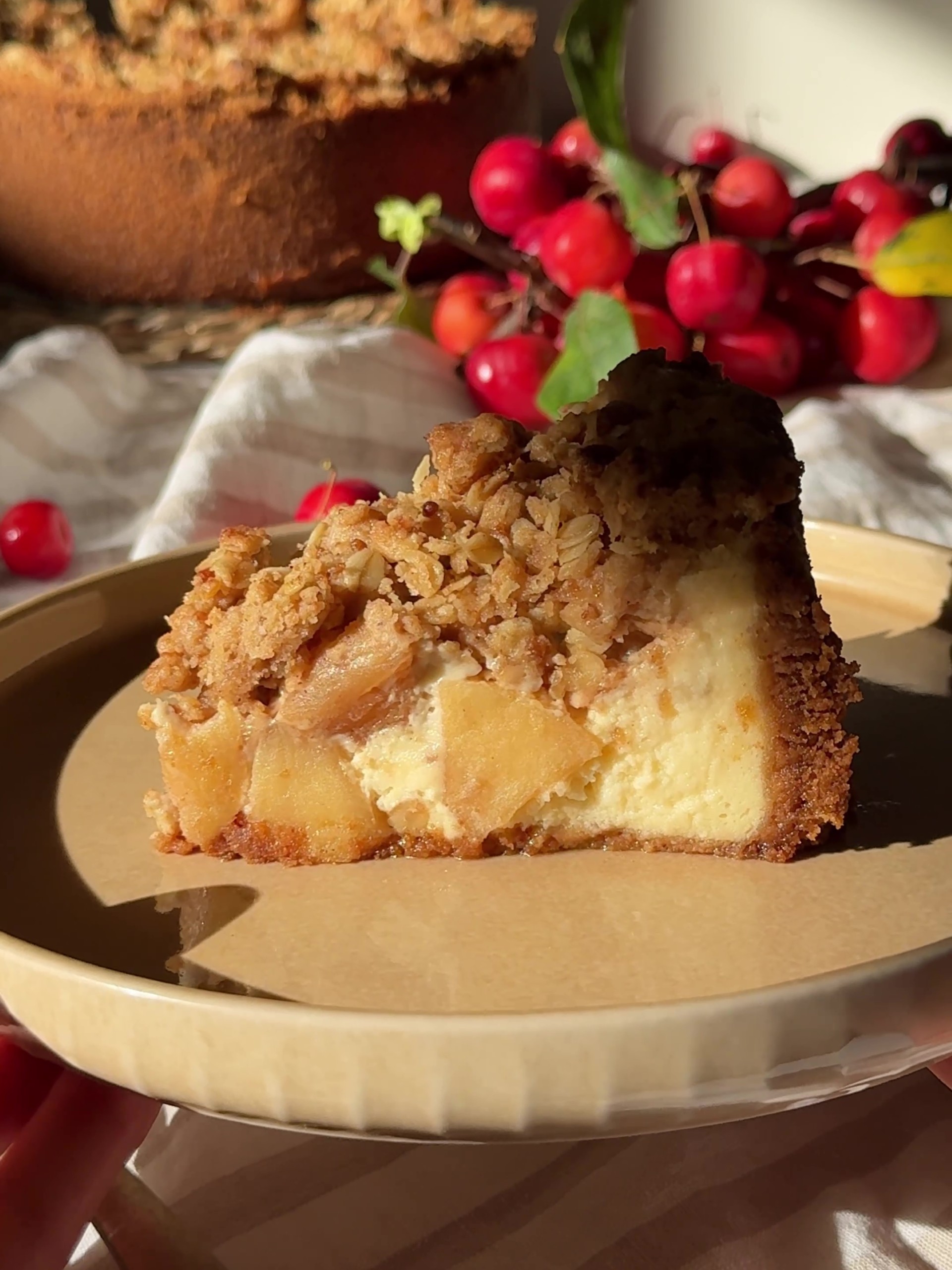 A slice of Apple Crumble Cheesecake in a plate