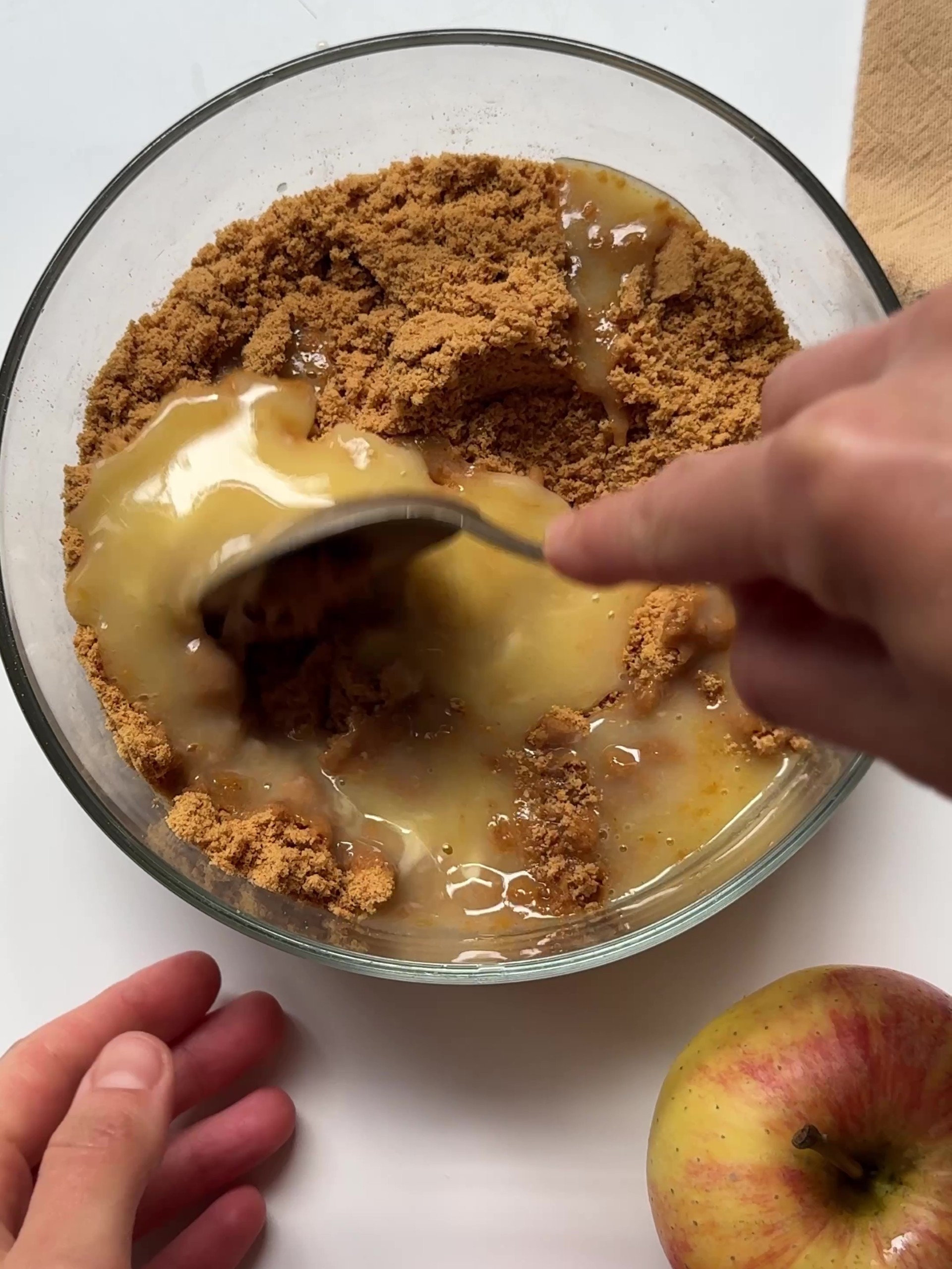 Adding melted butter to crumbed biscuits