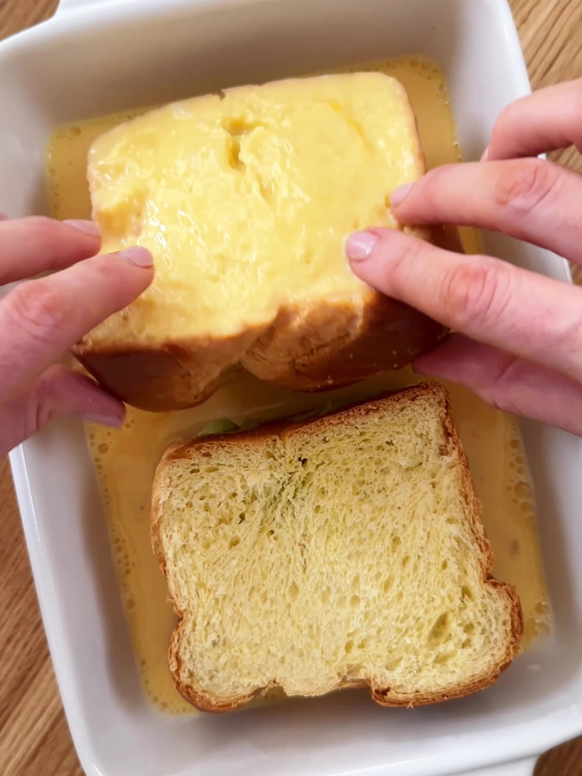 Dipping bread into an egg mixture