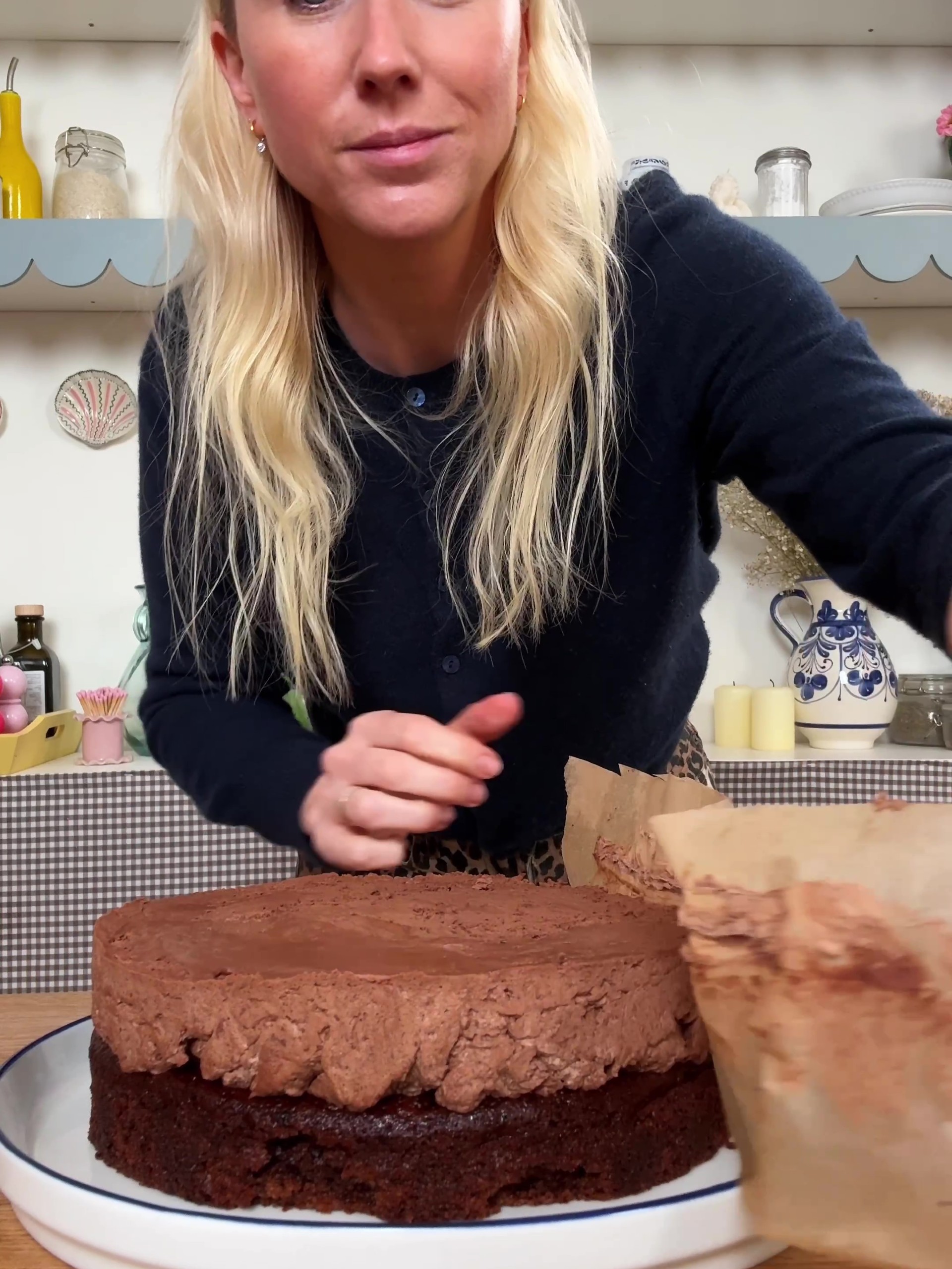 Peeling baking paper from chilled chocolate mousse cake