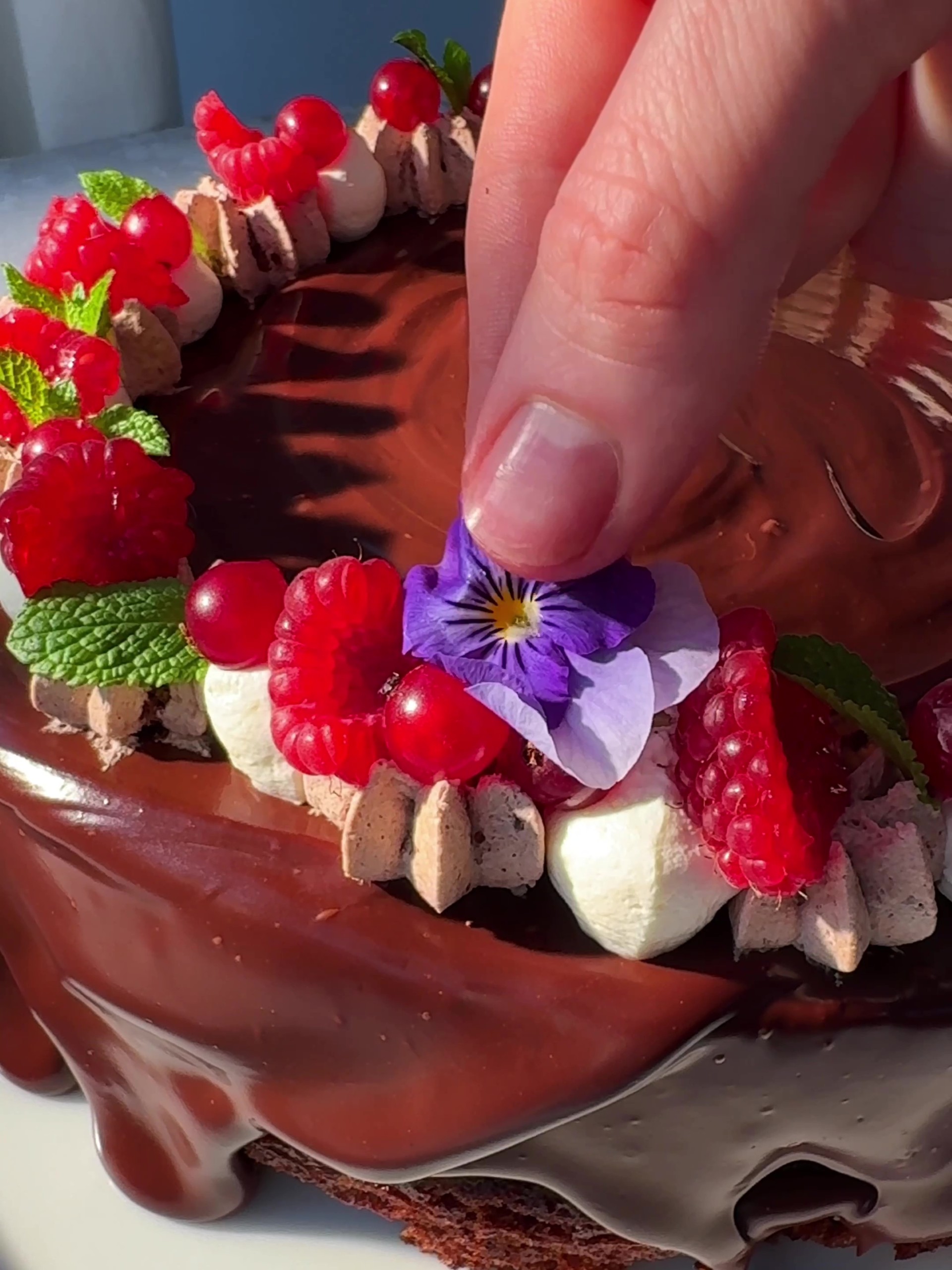 Decorating the cake with edible flowers