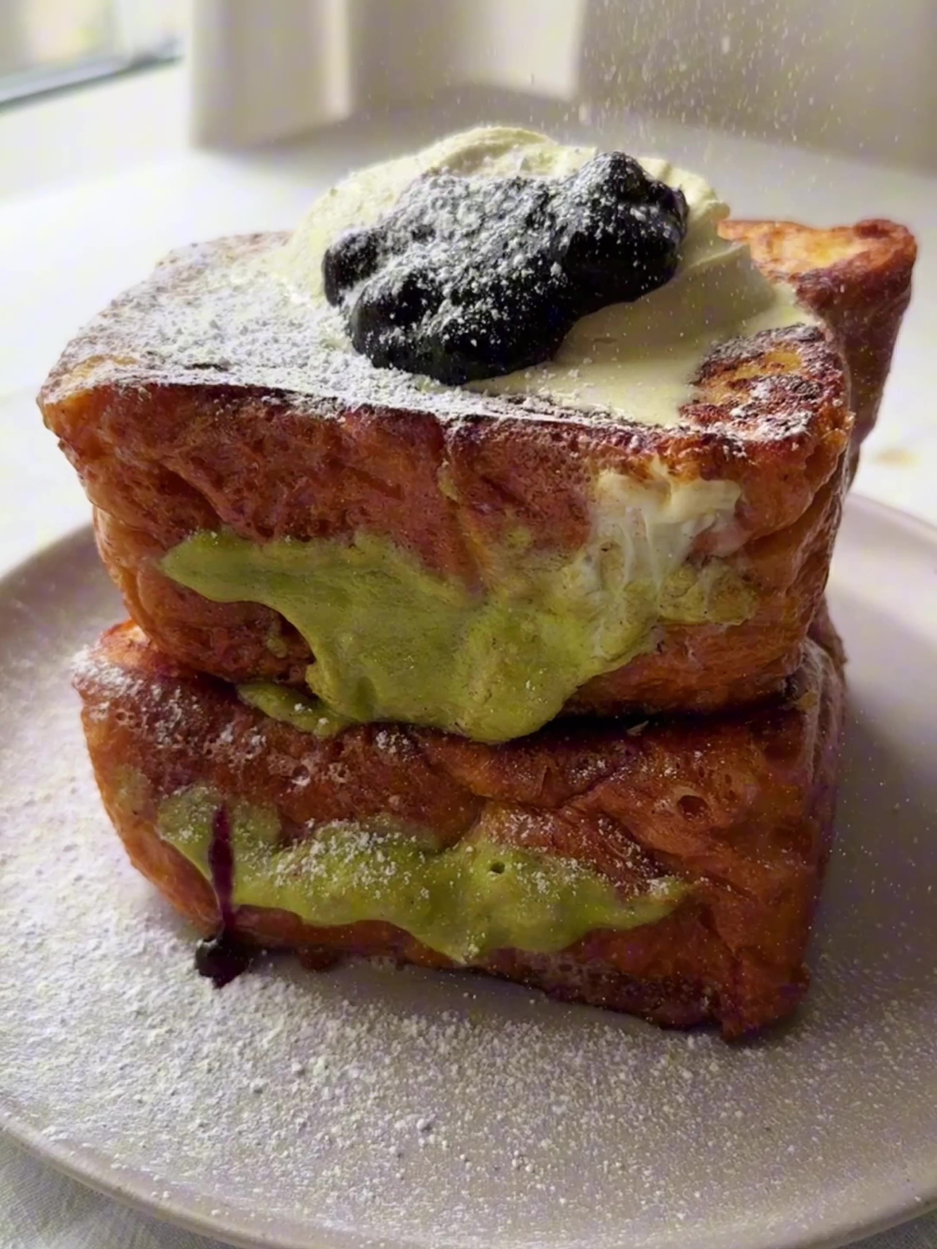 Pistachio Cream Brioche French Toast served in a plate