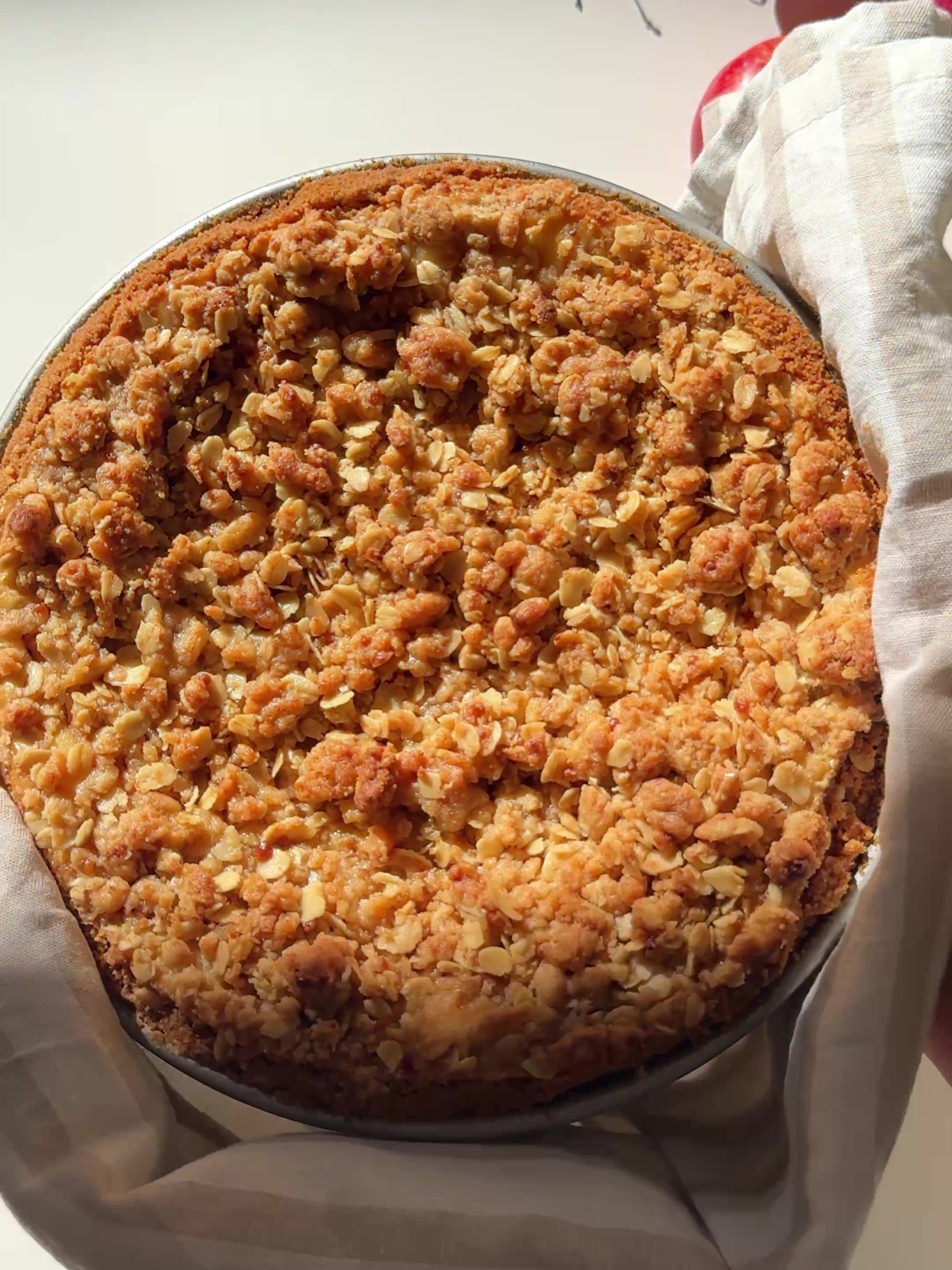 Removing the Apple Crumble Cheesecake from the oven