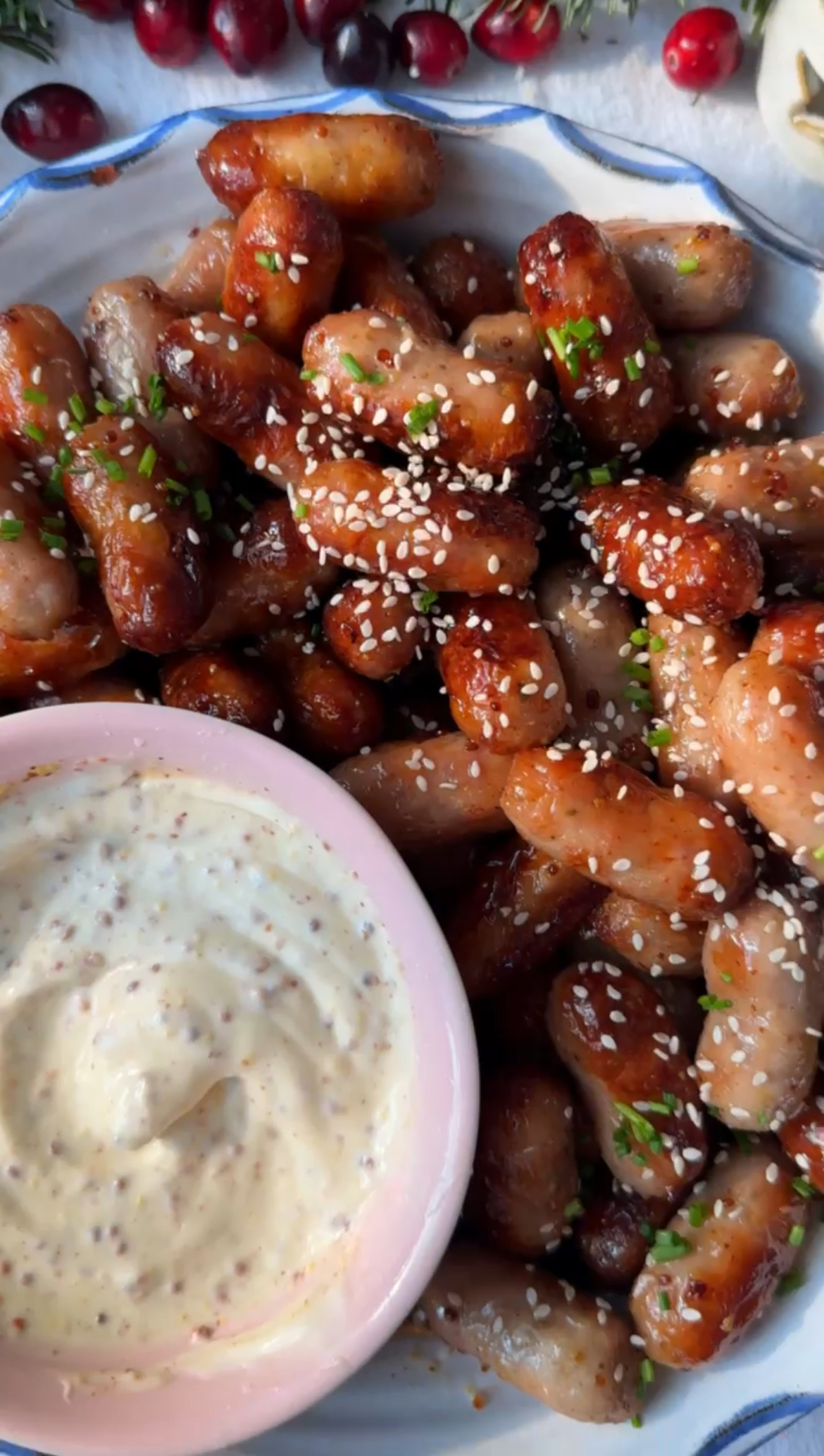 Serving Honey Mustard Sausages in a plate with a bowl of honey and mayo dip.