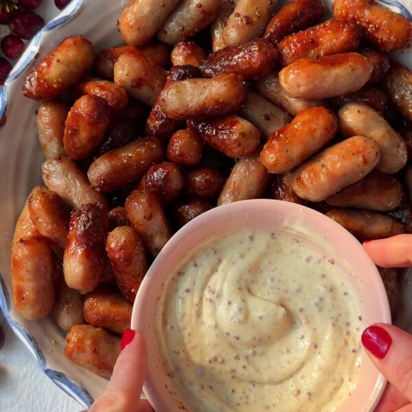 Honey Mustard Sausages in a plate with a dipping sauce.