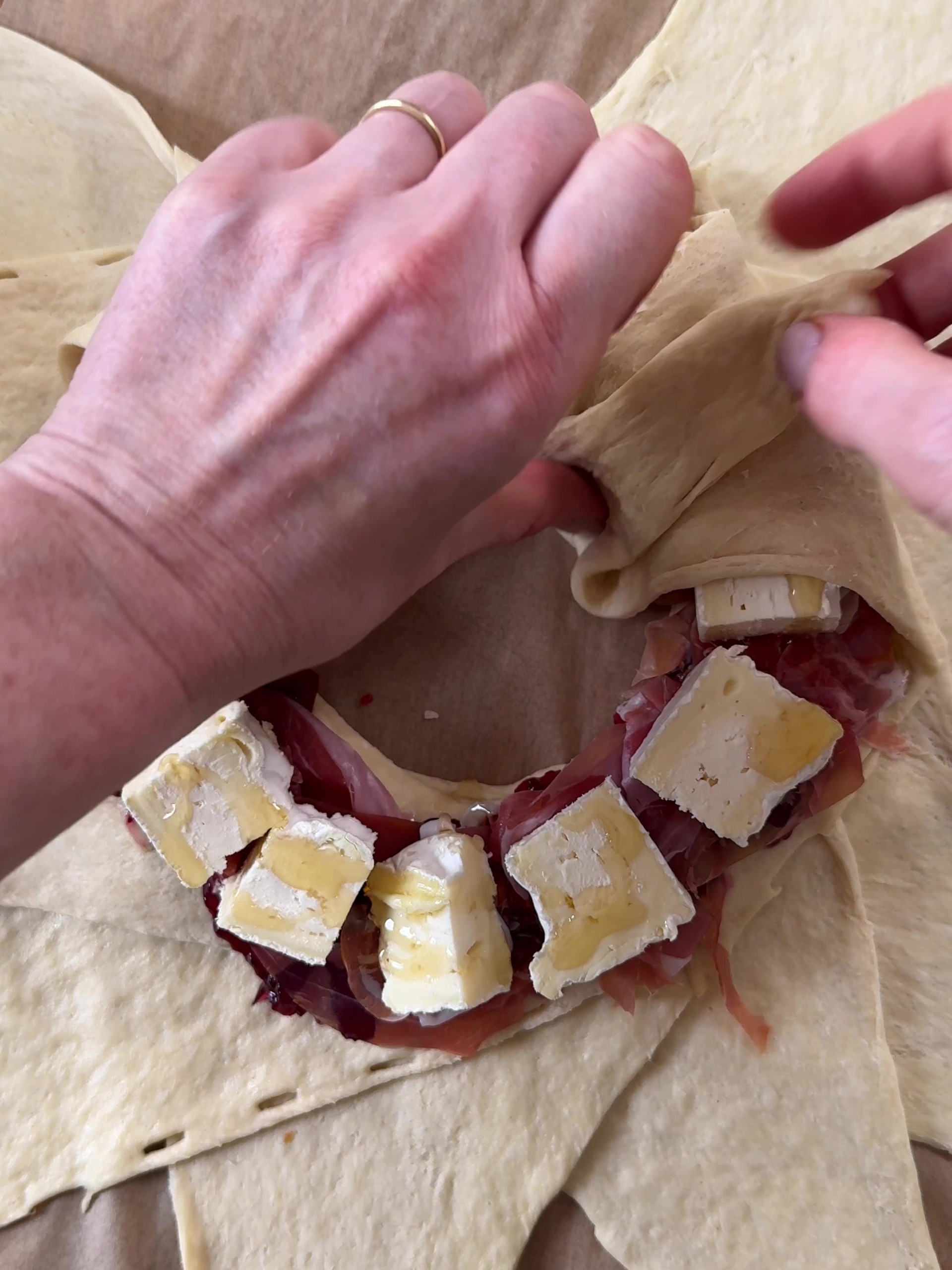 Folding the dough over the filling.