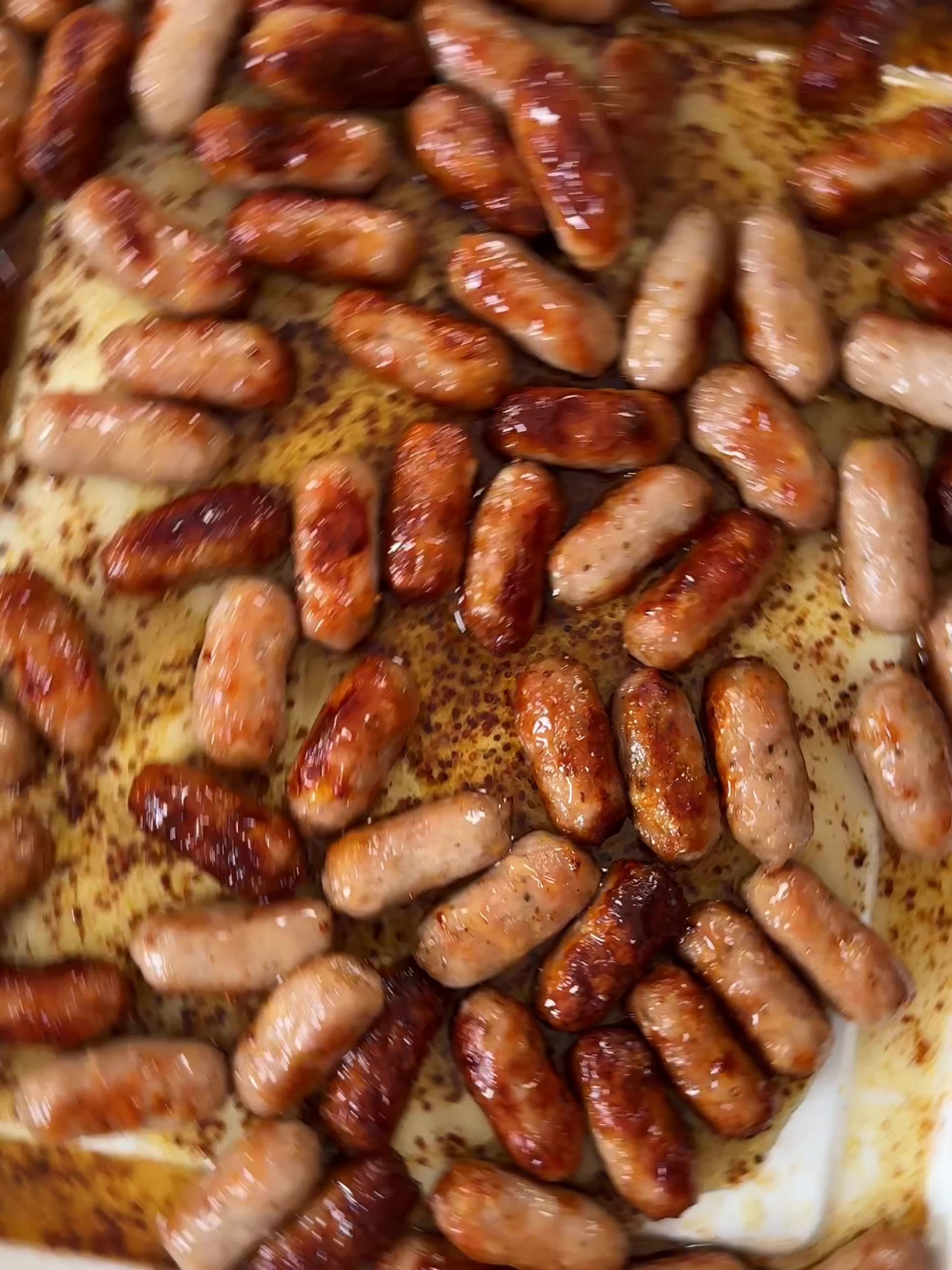 Fried sausages in a baking tin