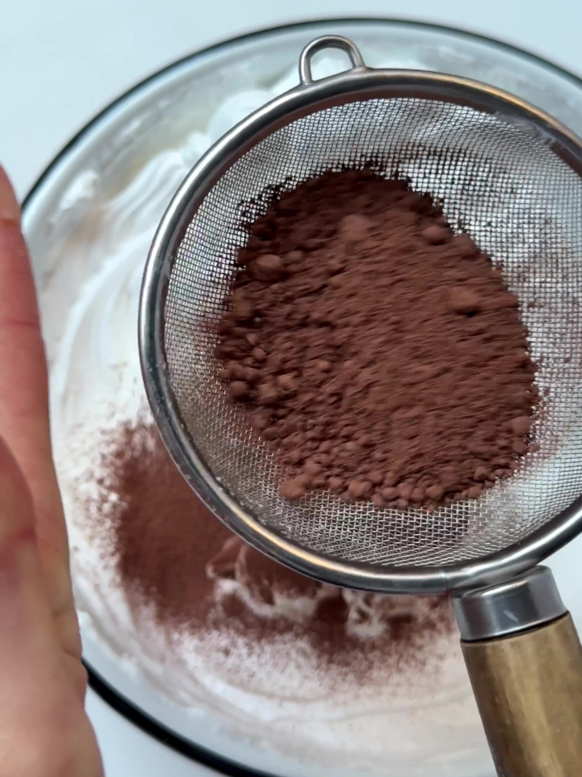 Adding cocoa powder to whipped egg whites