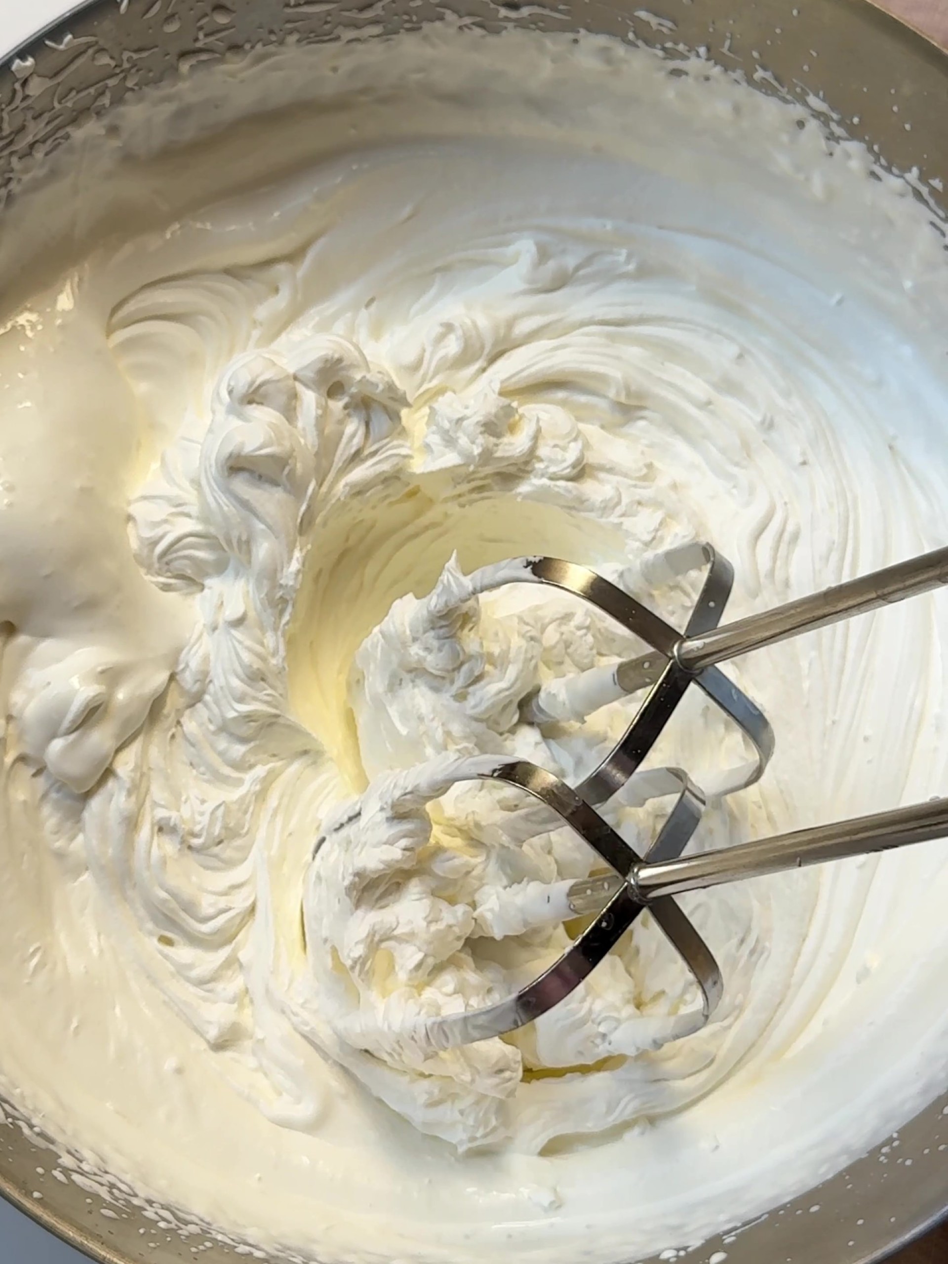 Whipping cream in a mixing bowl