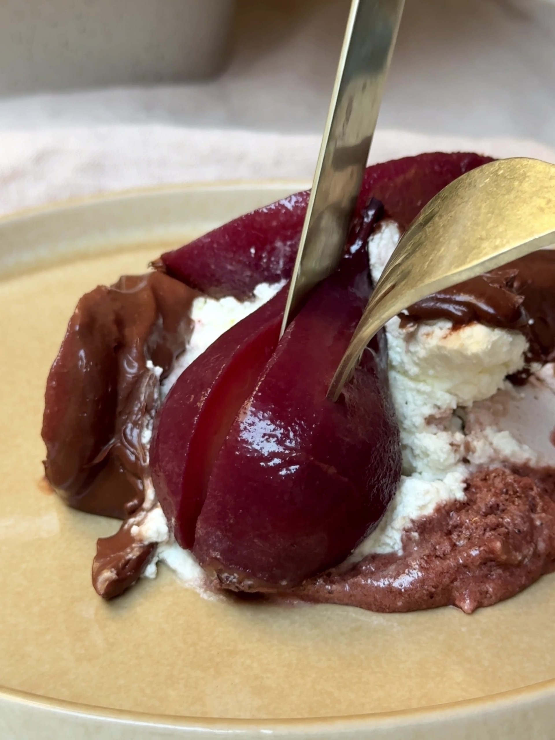 Slicing a piece of poached pears