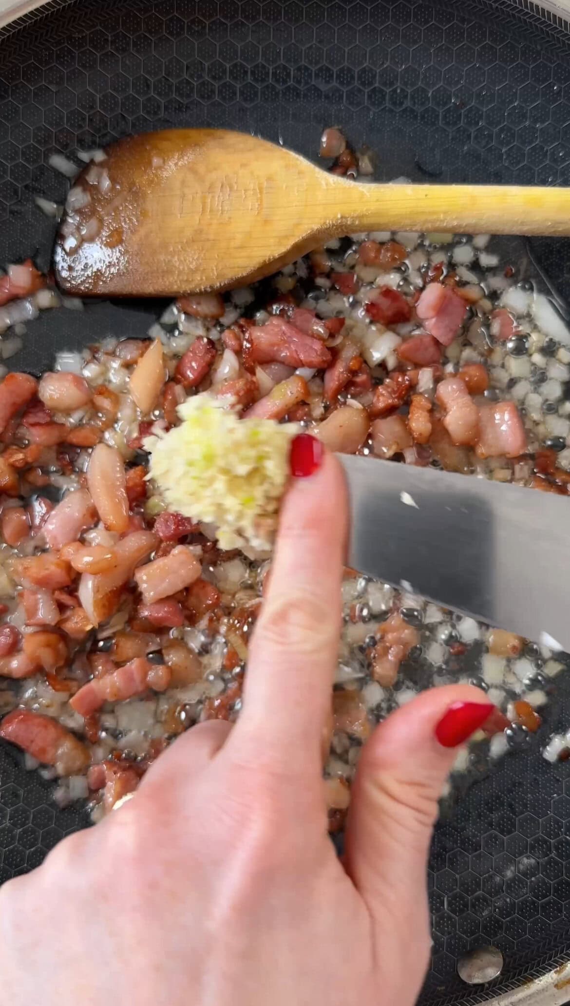 adding garlic to the pancetta.