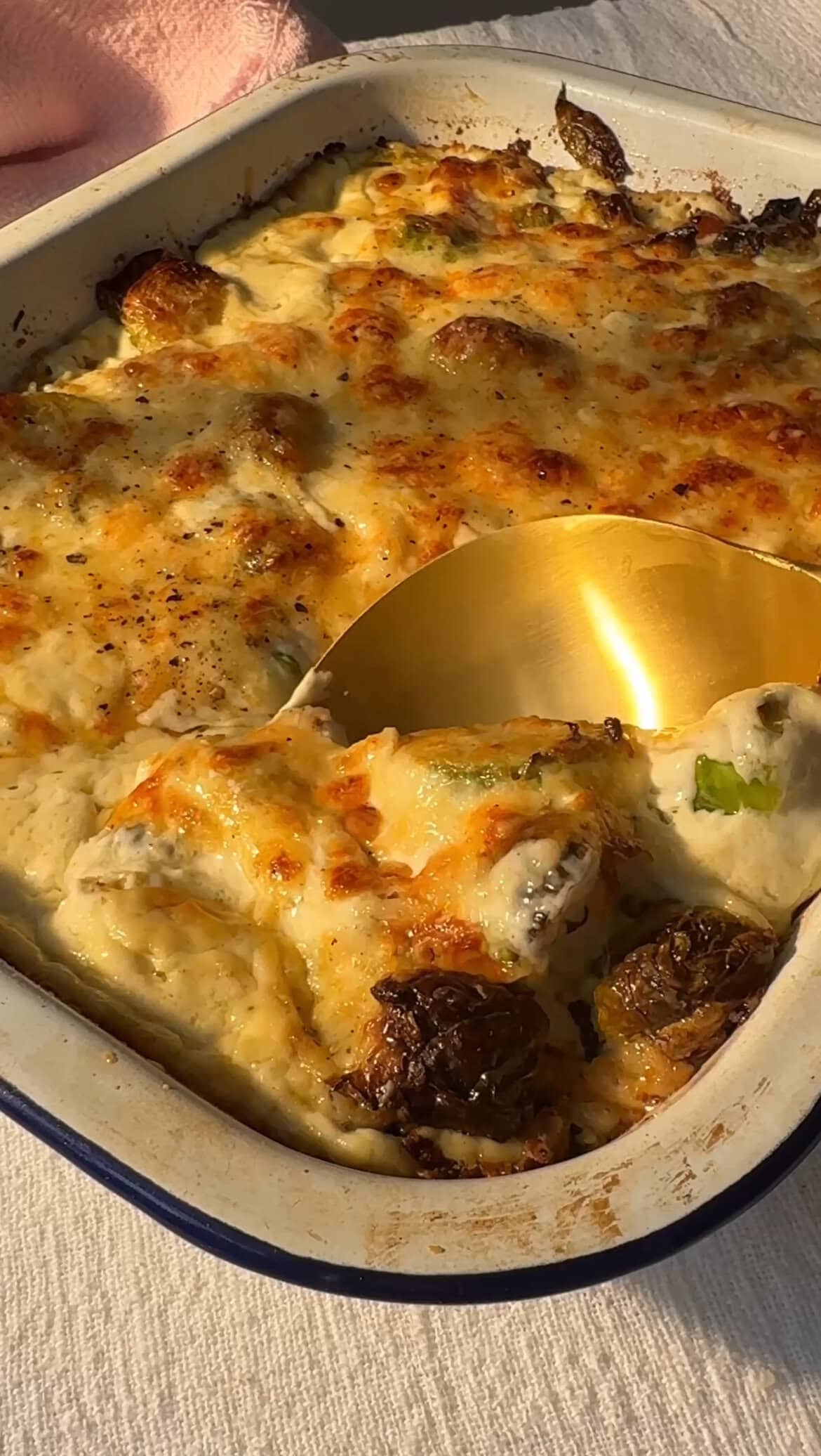 scooping a spoon of brussels sprout casserole.