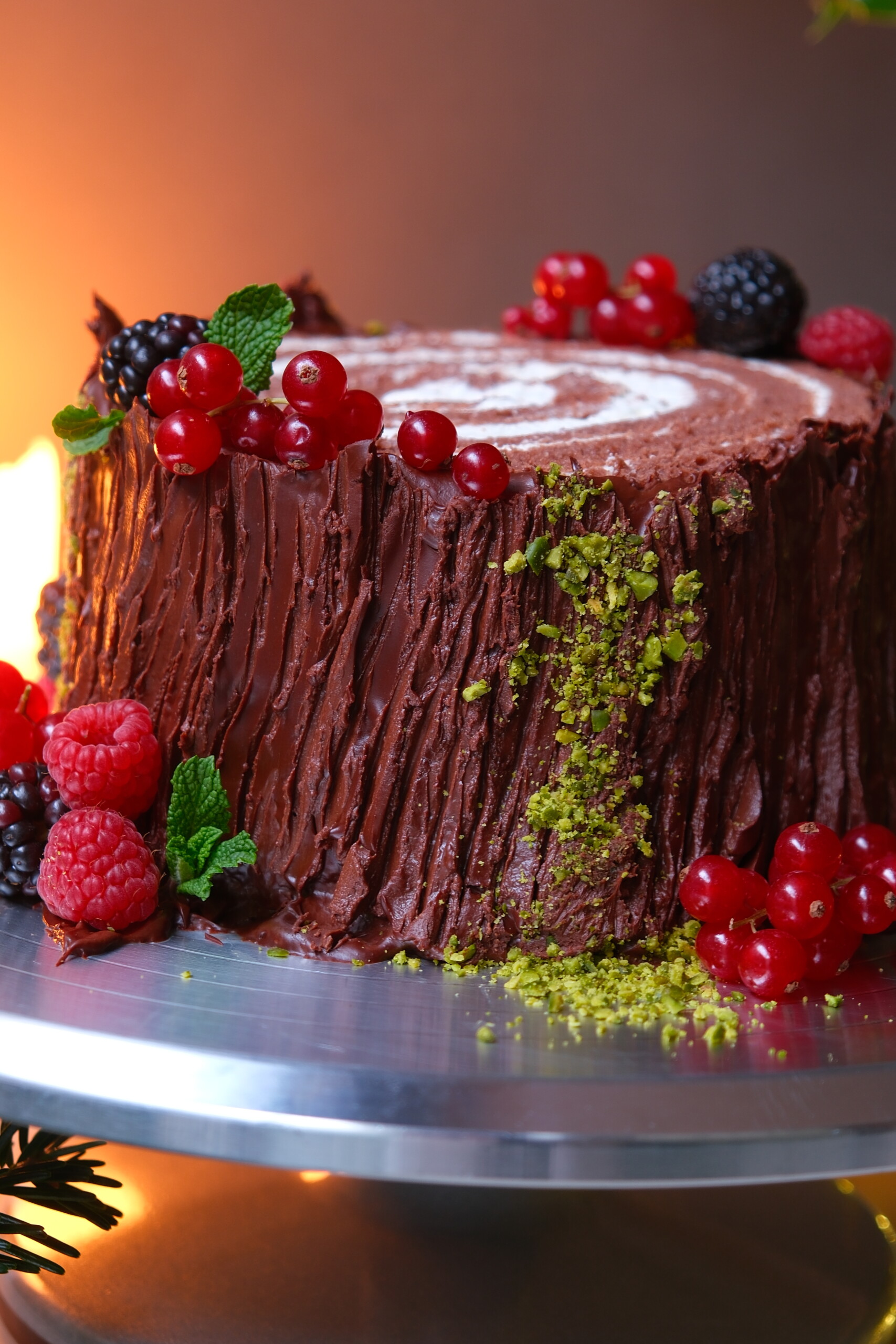 buche de noel on a plate with berries.