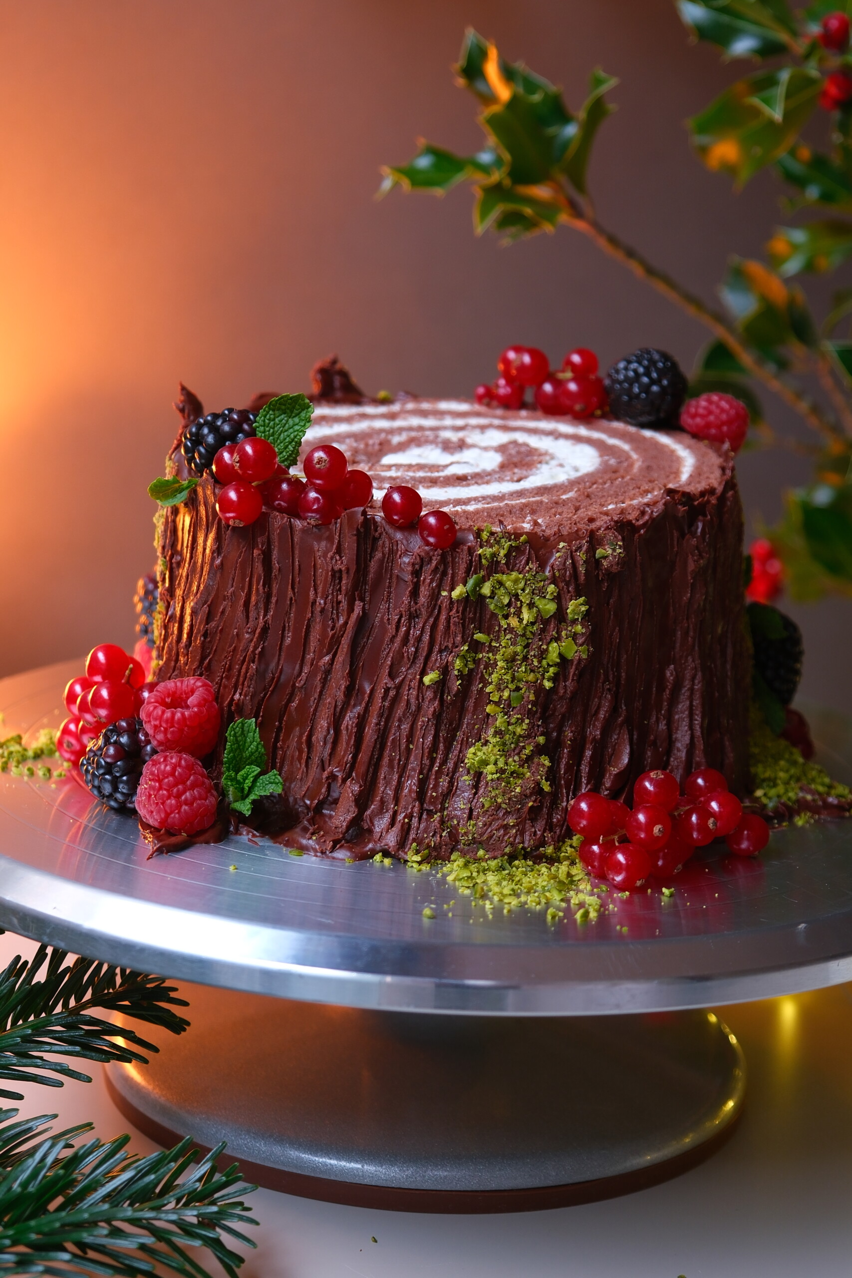 buche de noel on a plate with berries.