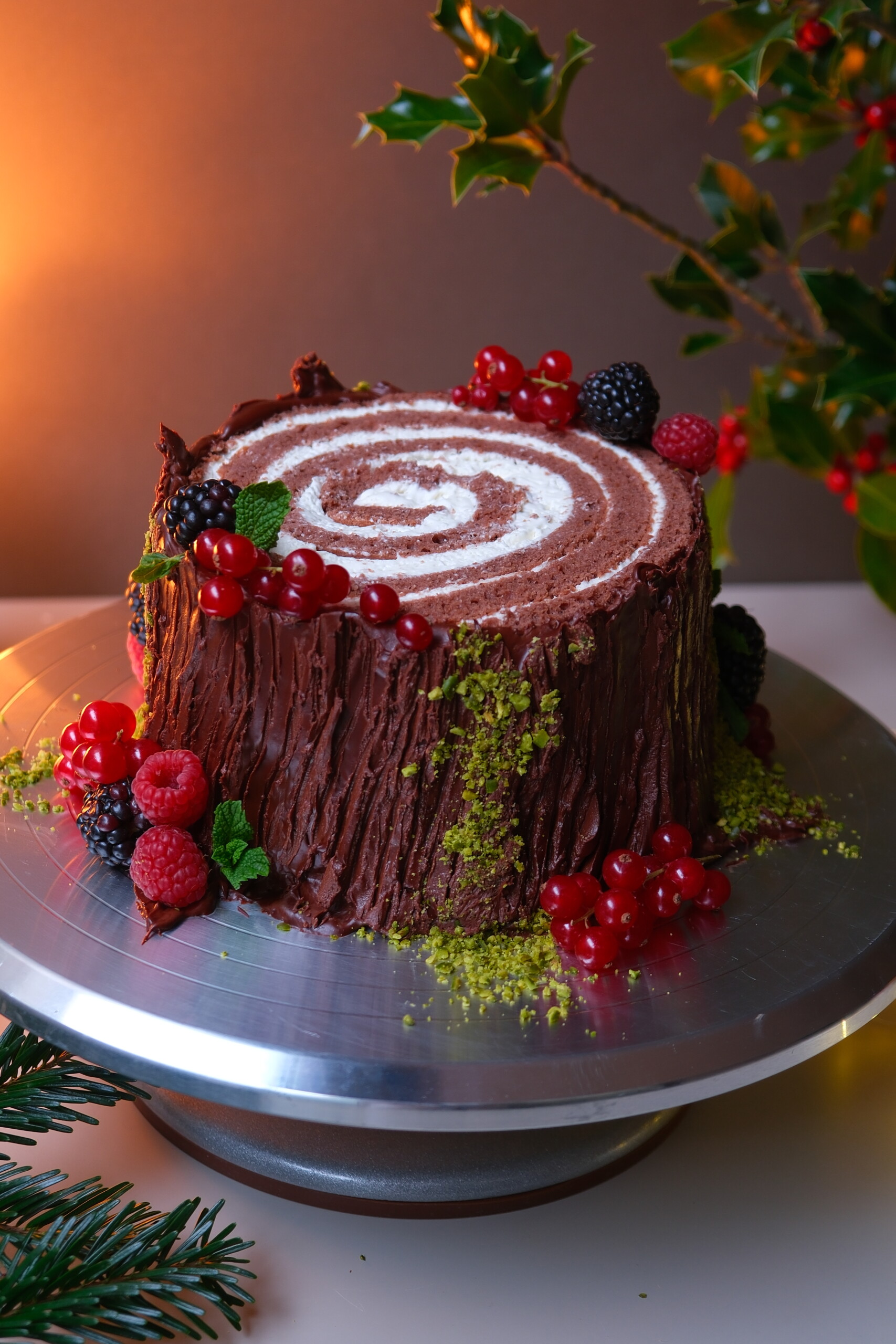 buche de noel on a plate with berries.