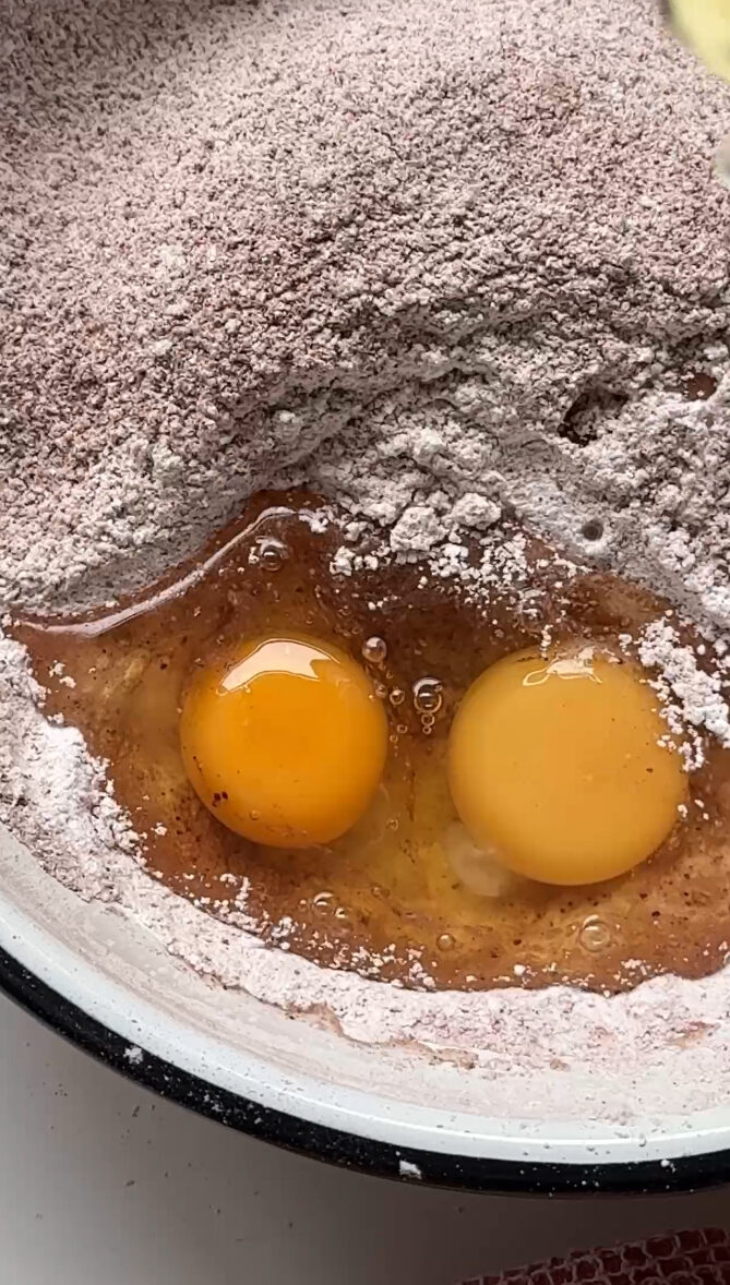 adding eggs to flour.