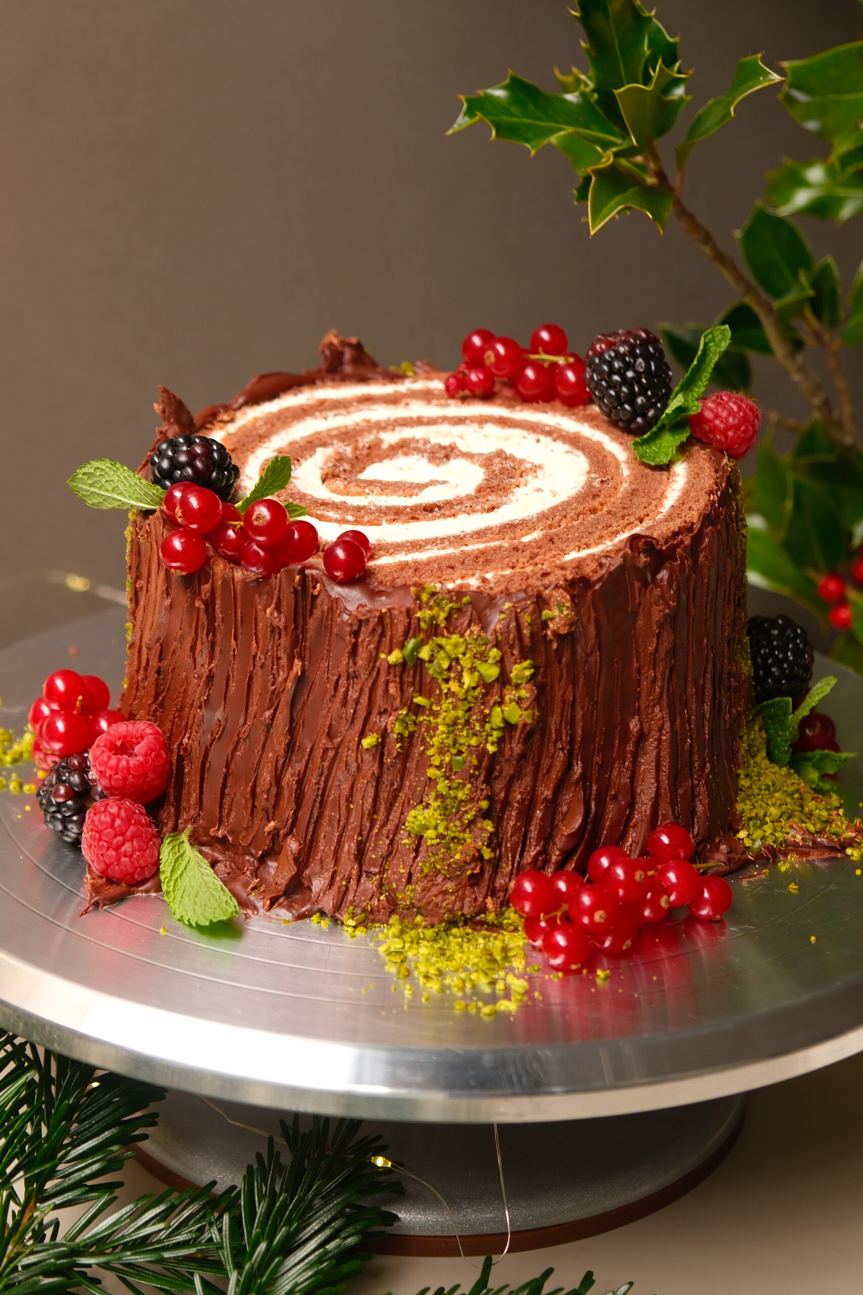 buche de noel on a plate with berries.