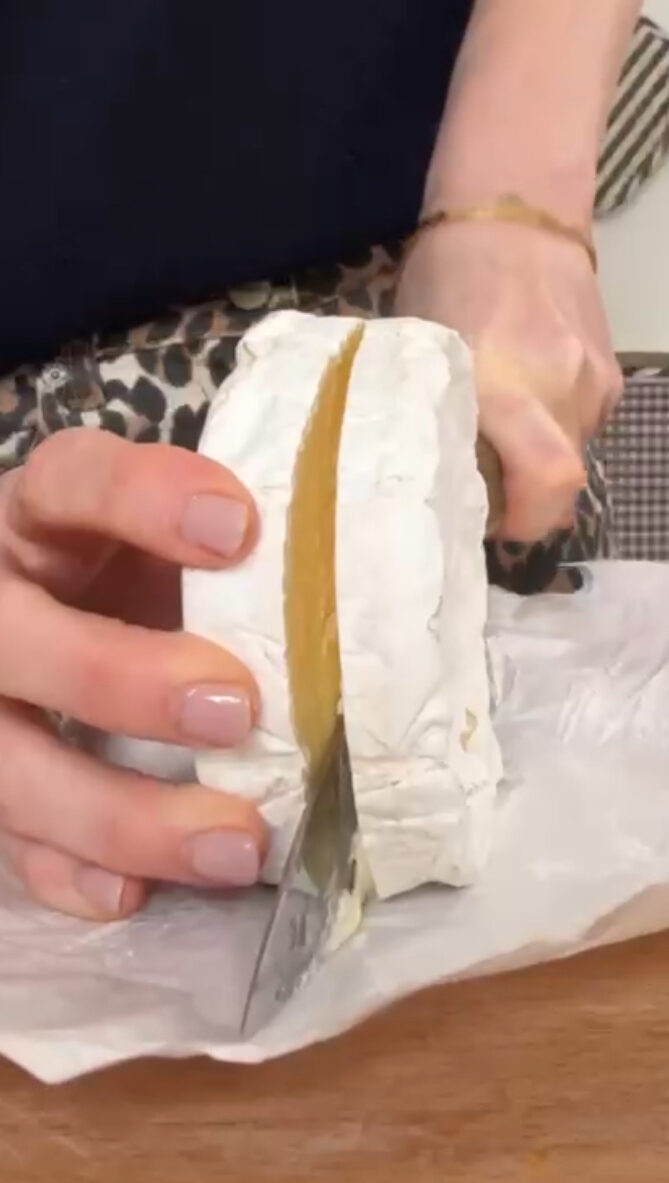 slicing camembert in half.