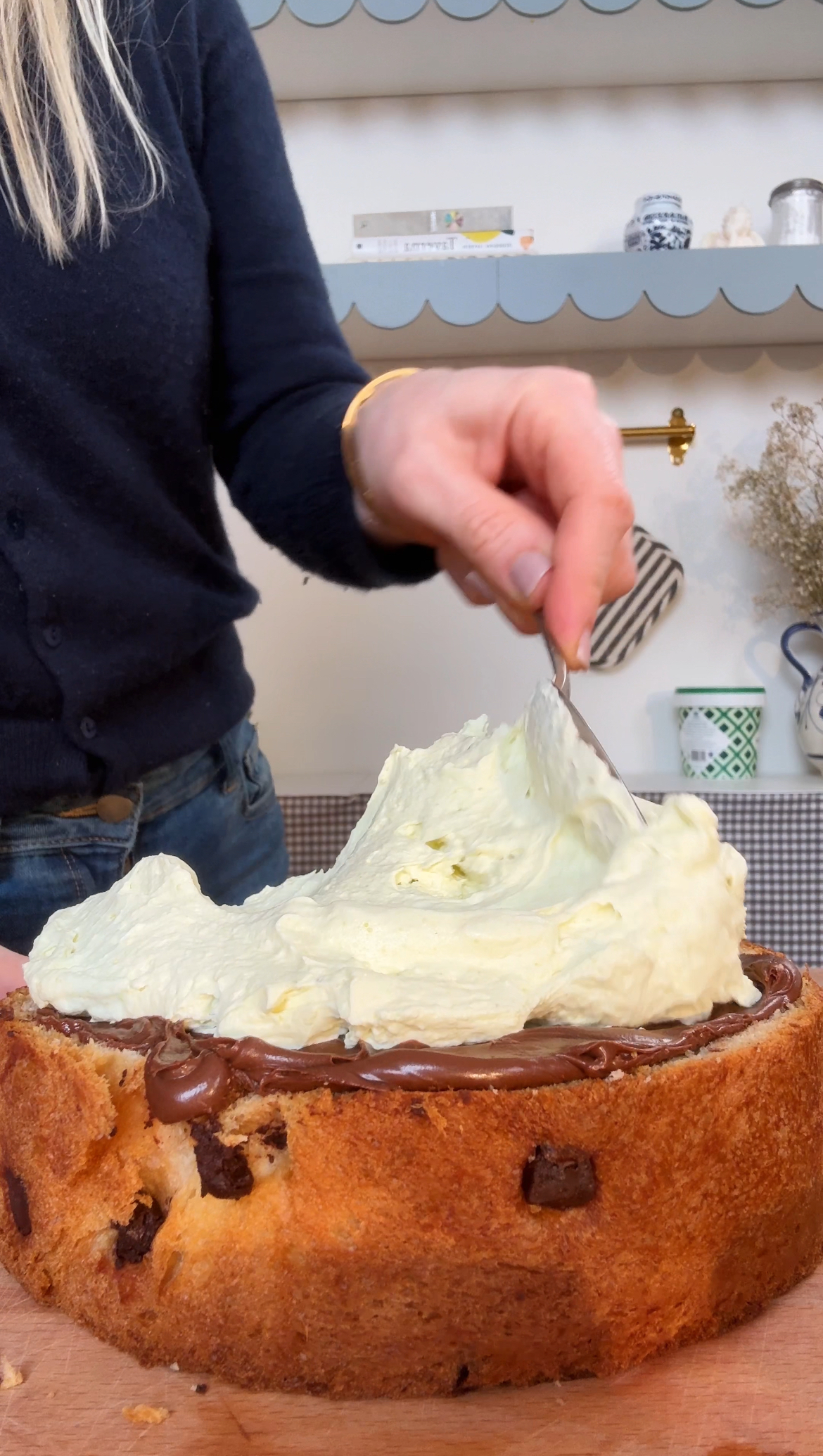 adding whipped cream to tiramisu cake.