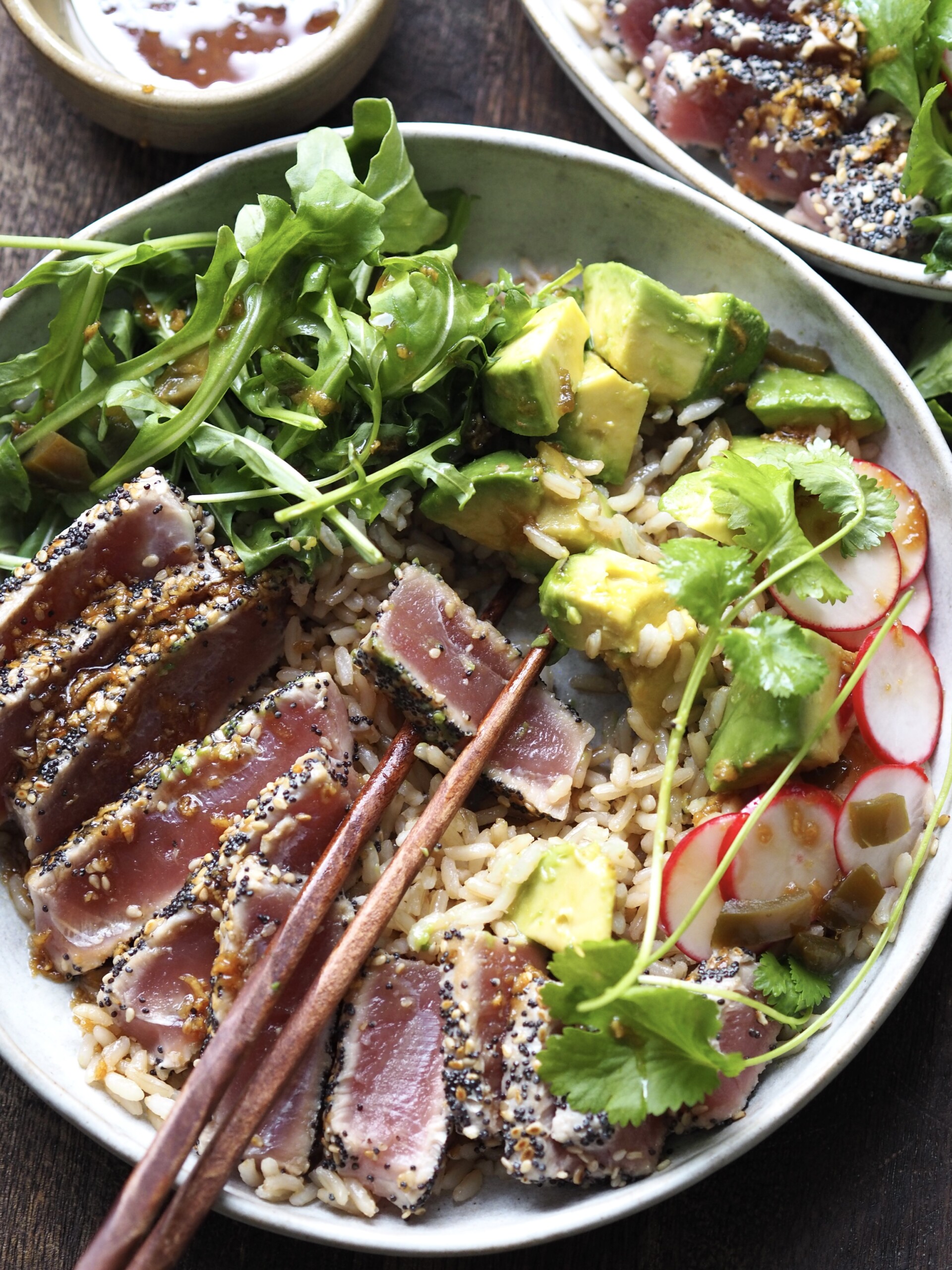 ahi tuna salad with chopsticks picking up a piece of tuna.