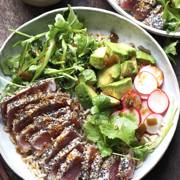 ahi tuna salad with garnishes on a white plate