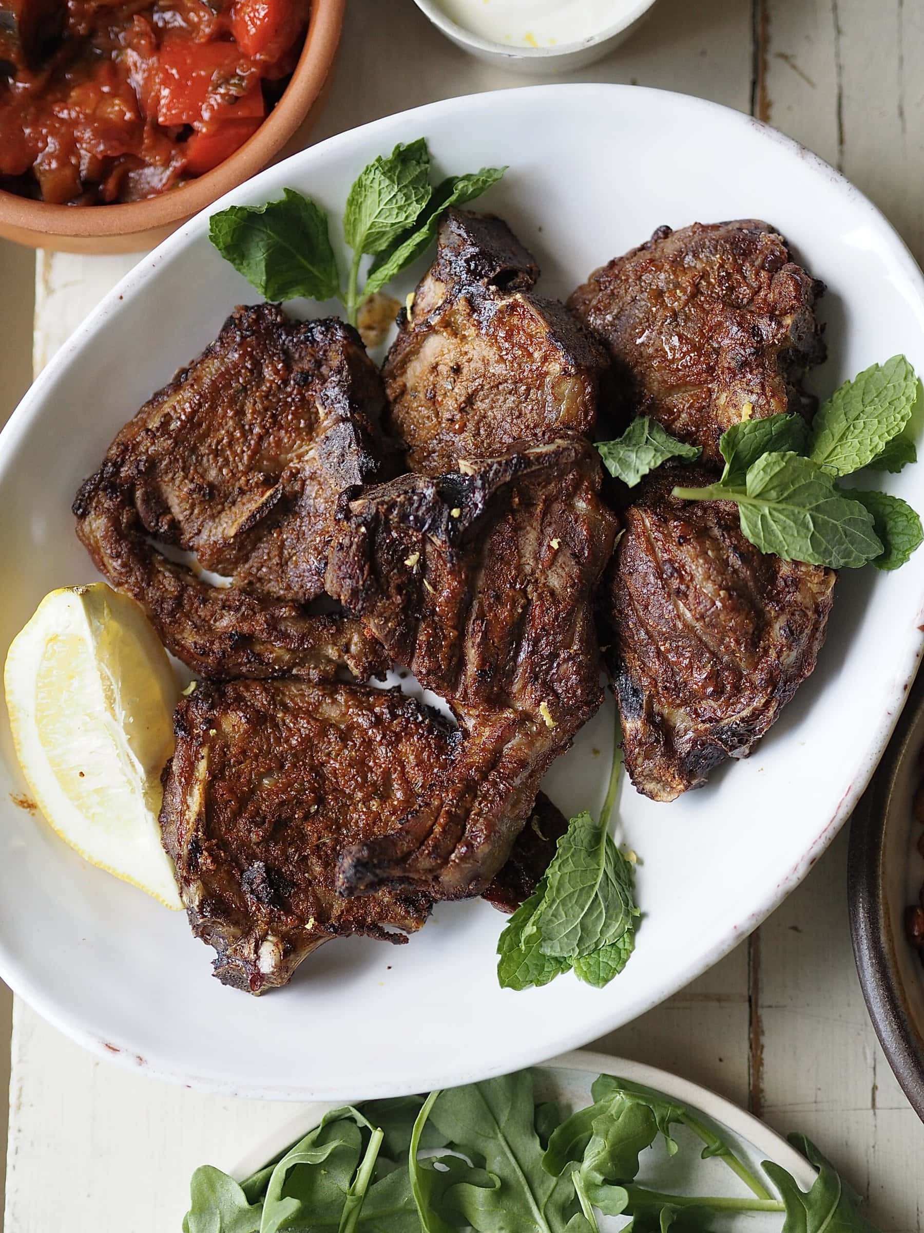 air fryer lamb chops on a white plate.