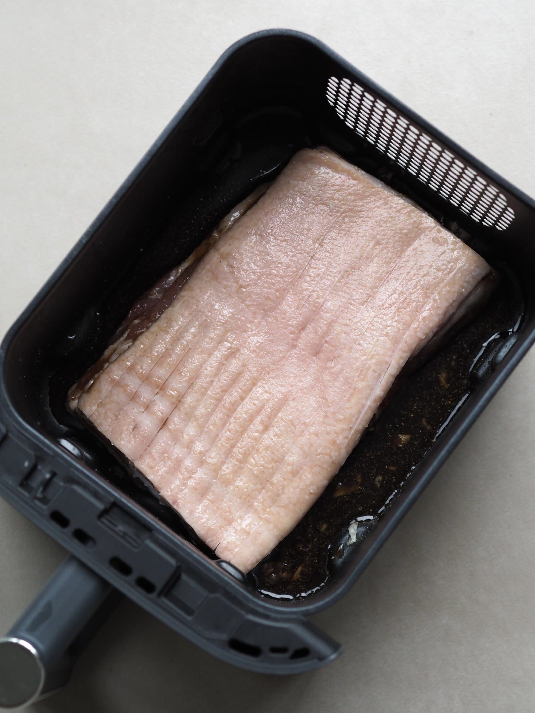 pork belly in air fryer before cooking.