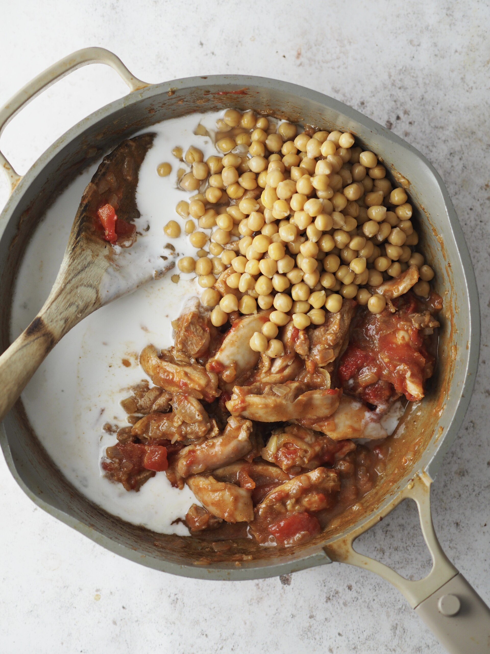 adding chickpeas and coconut milk.