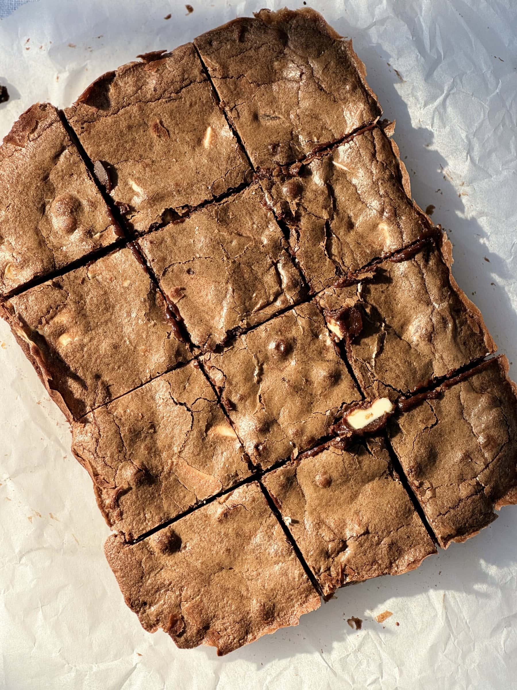 overhead shot of sliced brownies on greaseproof paper.