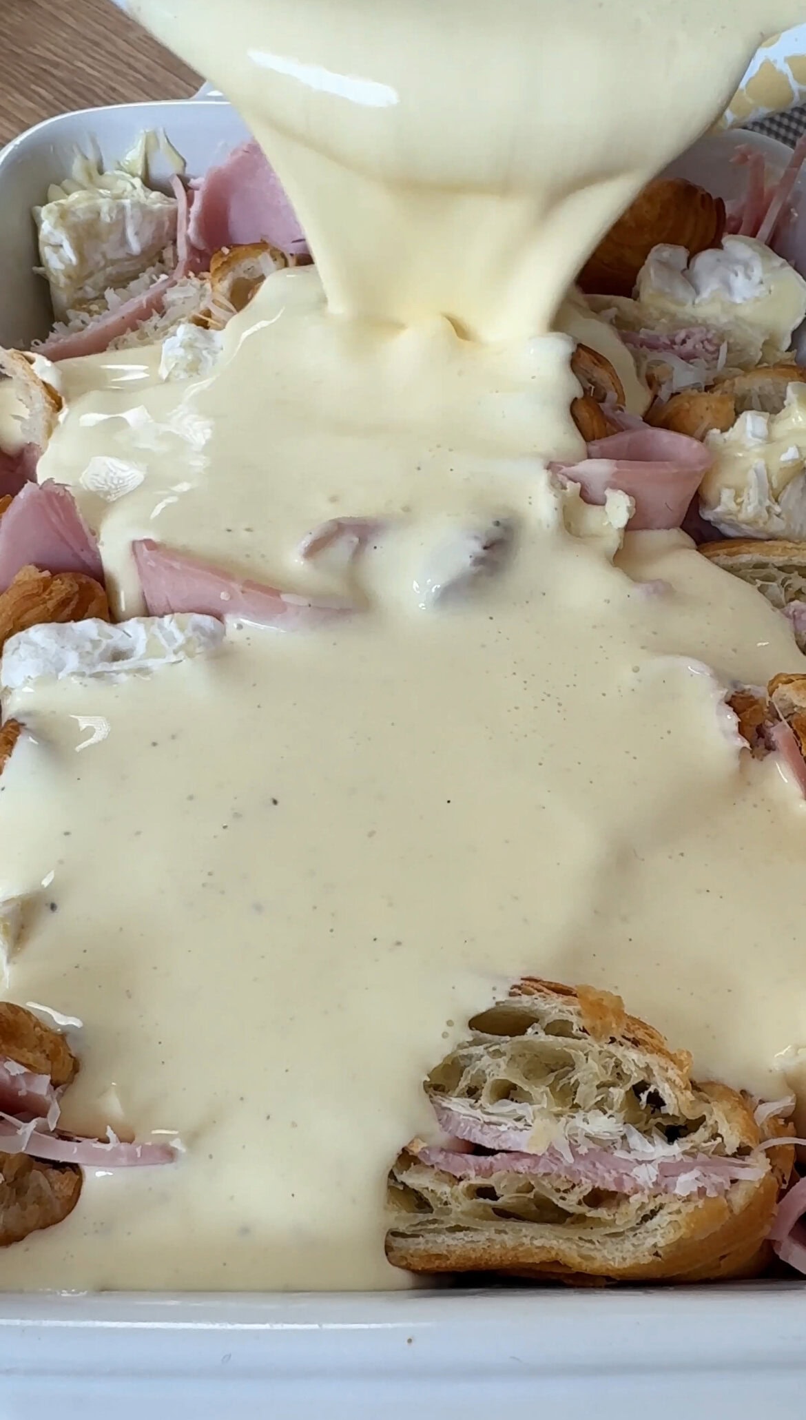 pouring croissant over the bake.