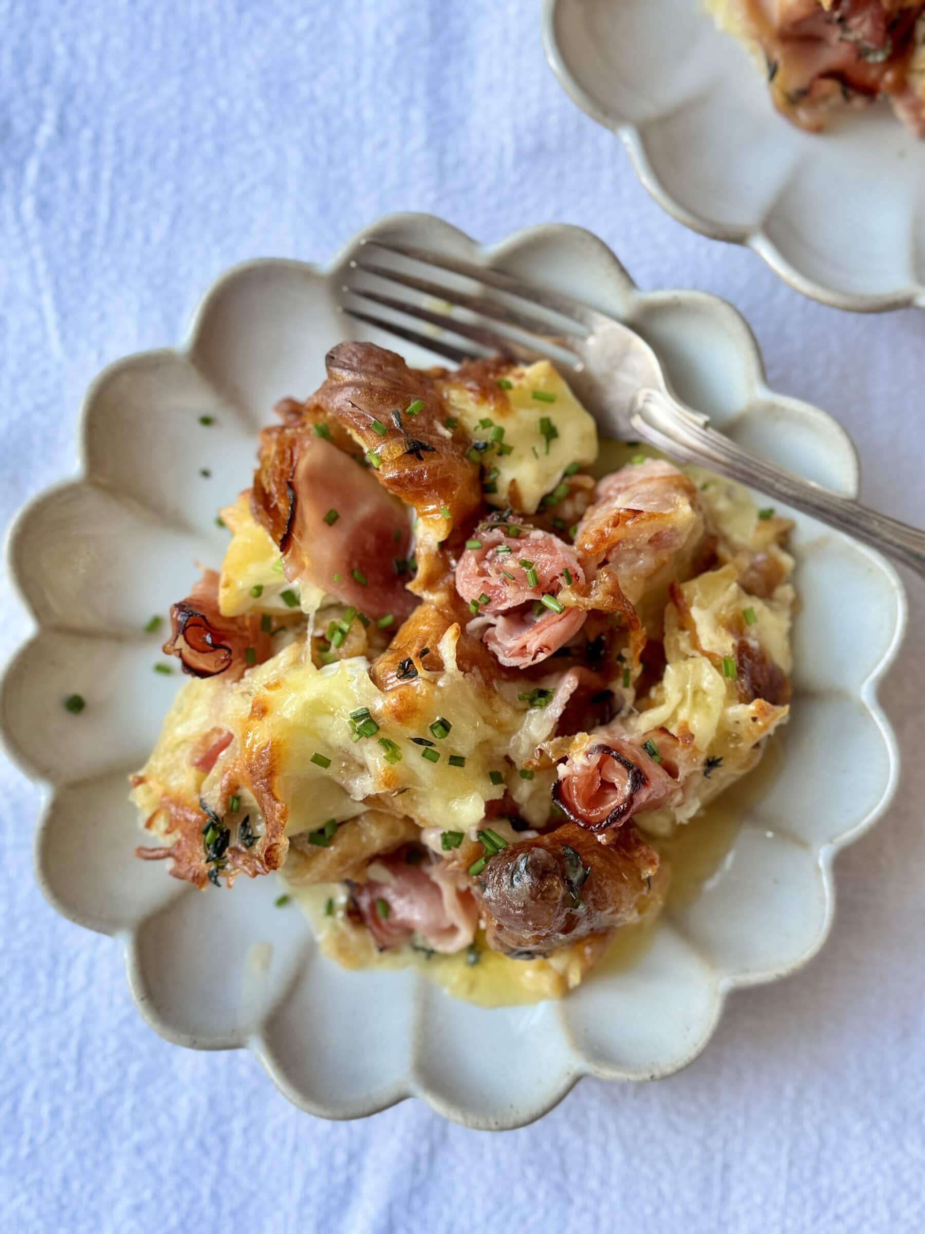 portion of ham and cheese croissant bake on a plate.