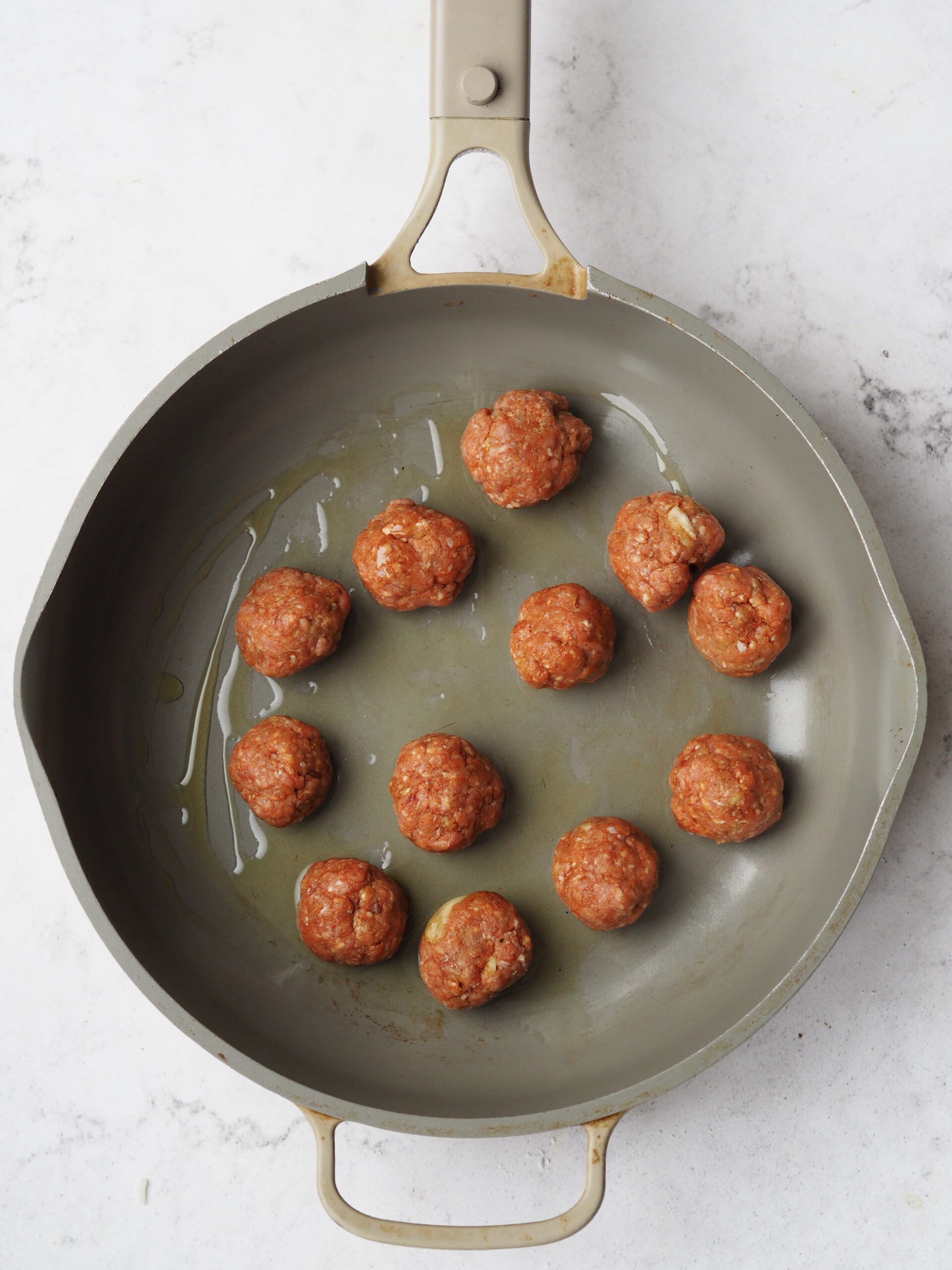 FRYING lamb meatballs.