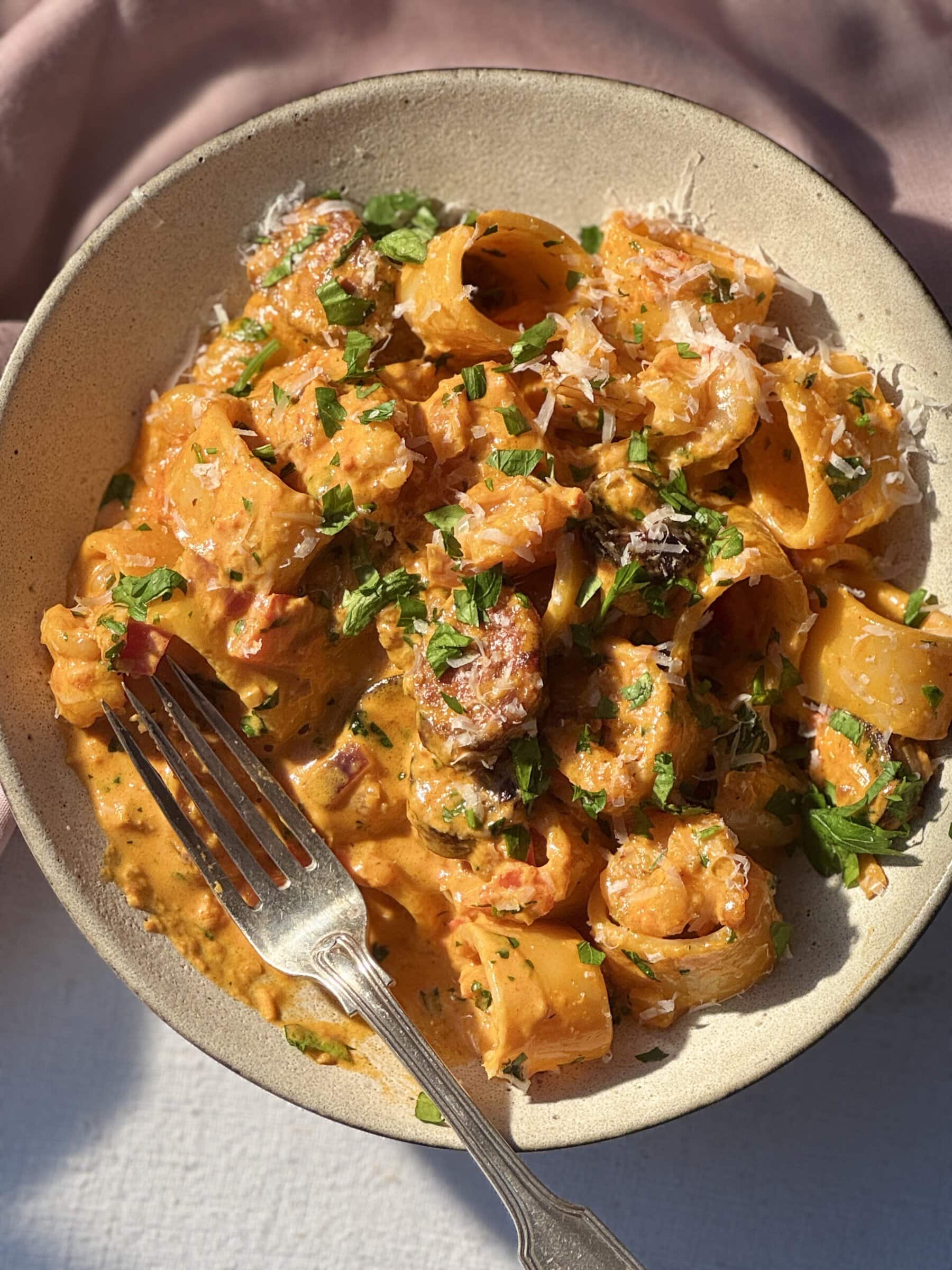 prawn chorizo pasta in beige bowl.