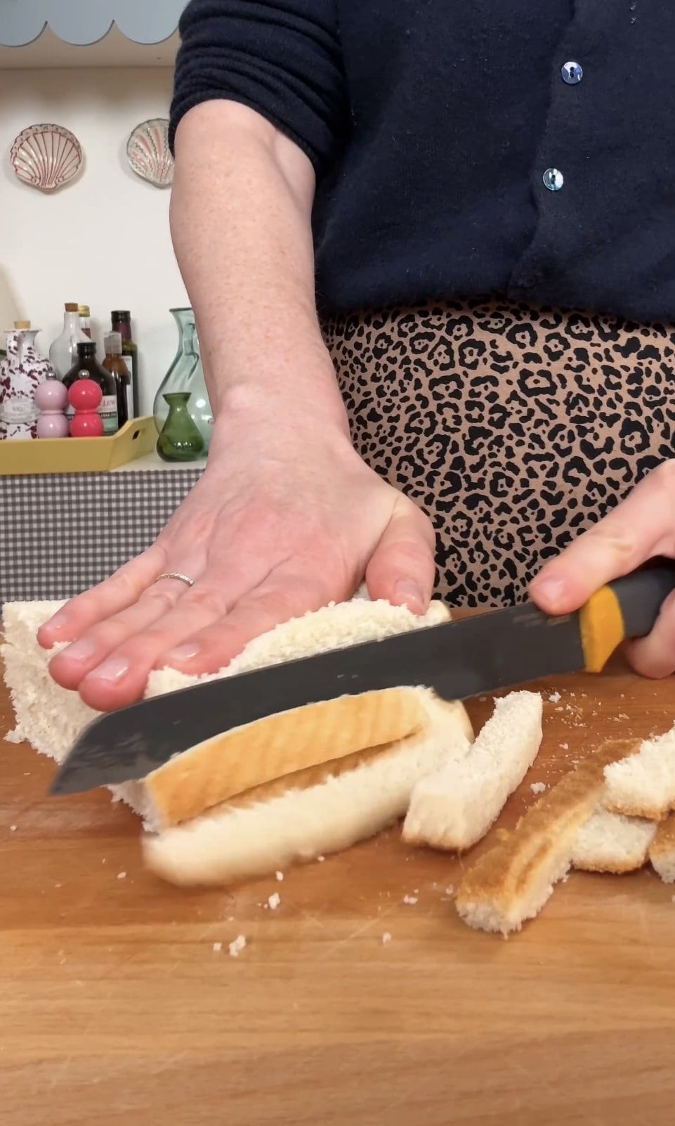 slicing crusts off white bread.